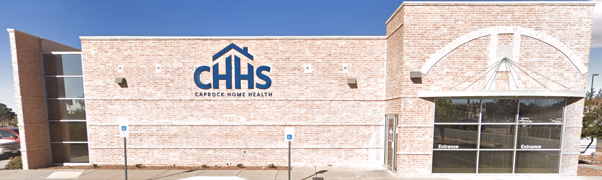 Brick building front with CHHS Caprock Home Health sign and glass entrance.