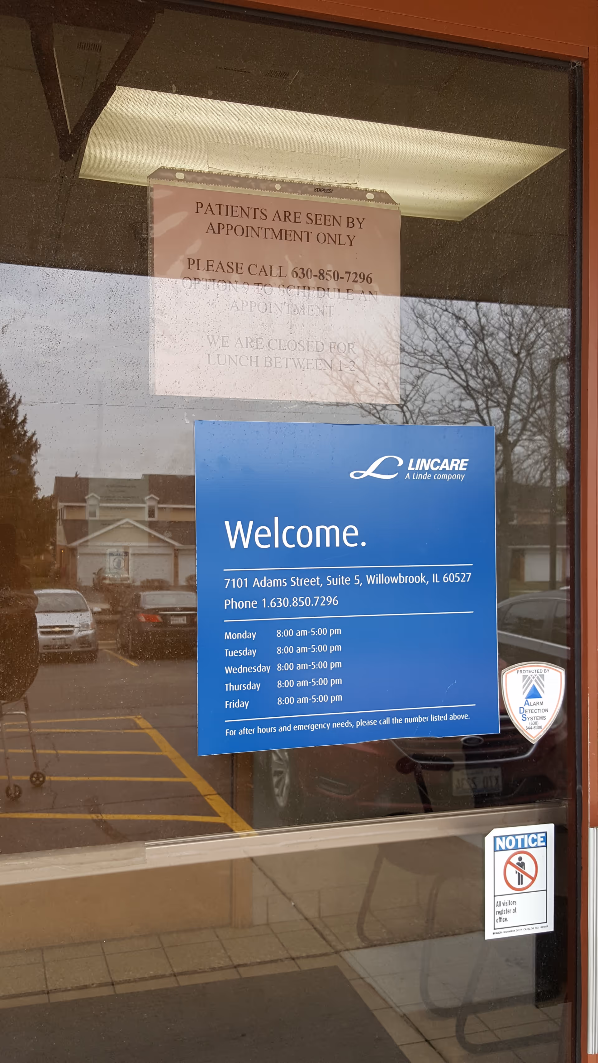 Blue Lincare welcome sign on a glass door at the facility entrance.