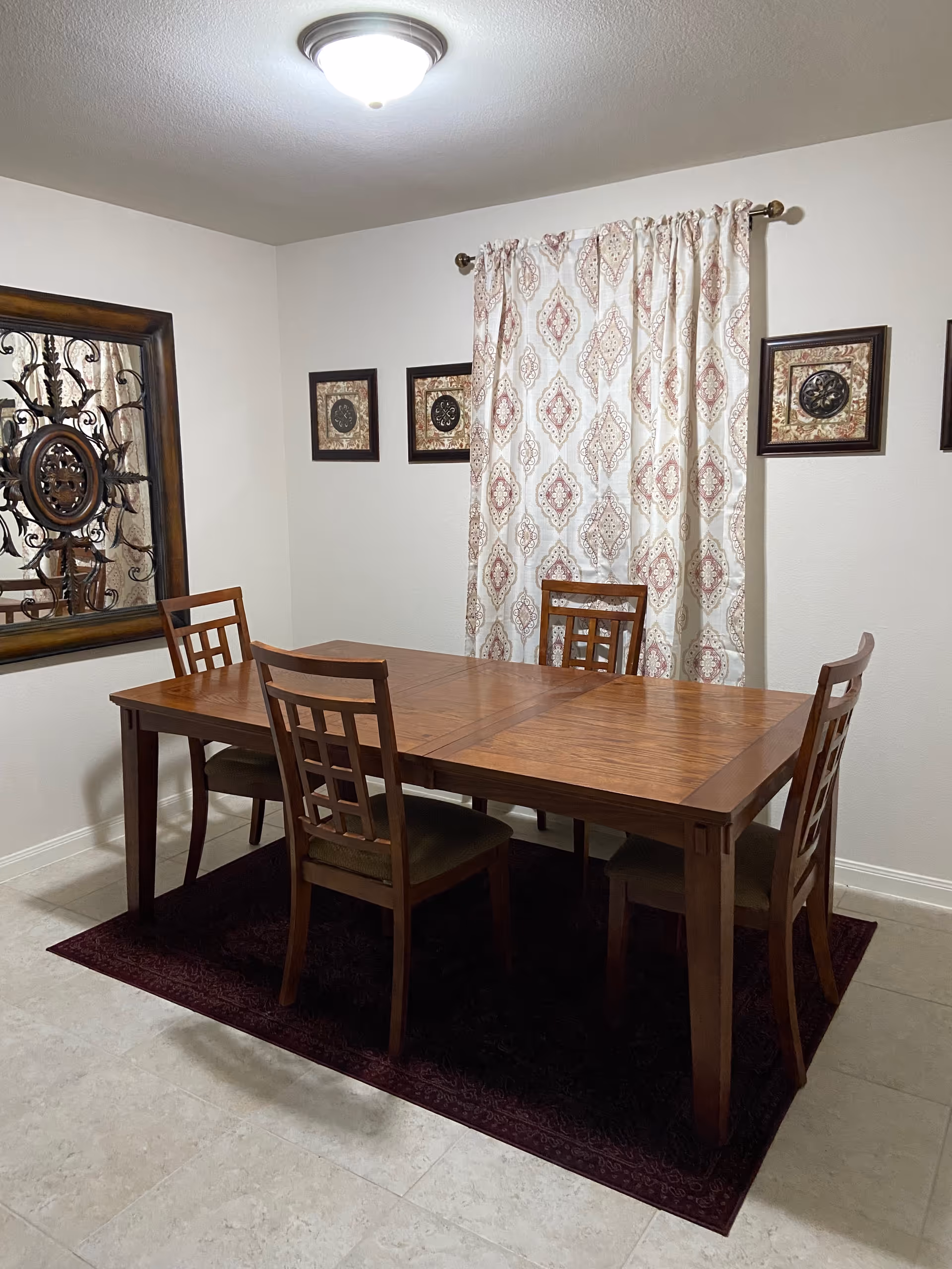 Wood dining table with six chairs in a dining room.