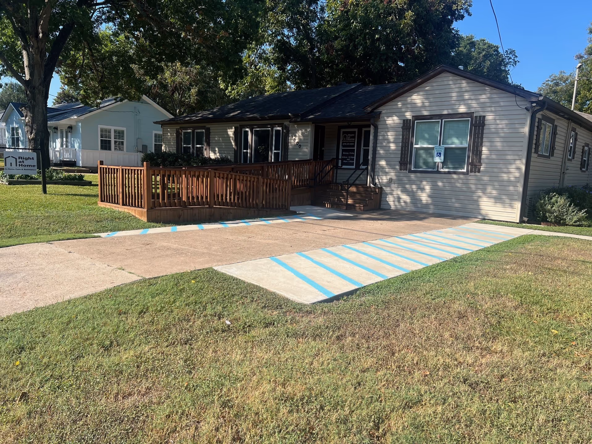 Exterior view of Right at Home facility with wooden ramp and sign.