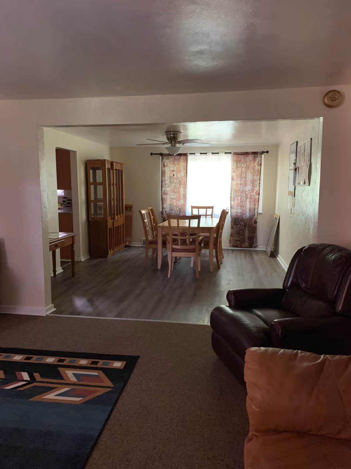 Living room opens to a dining area with a wooden table and chairs.
