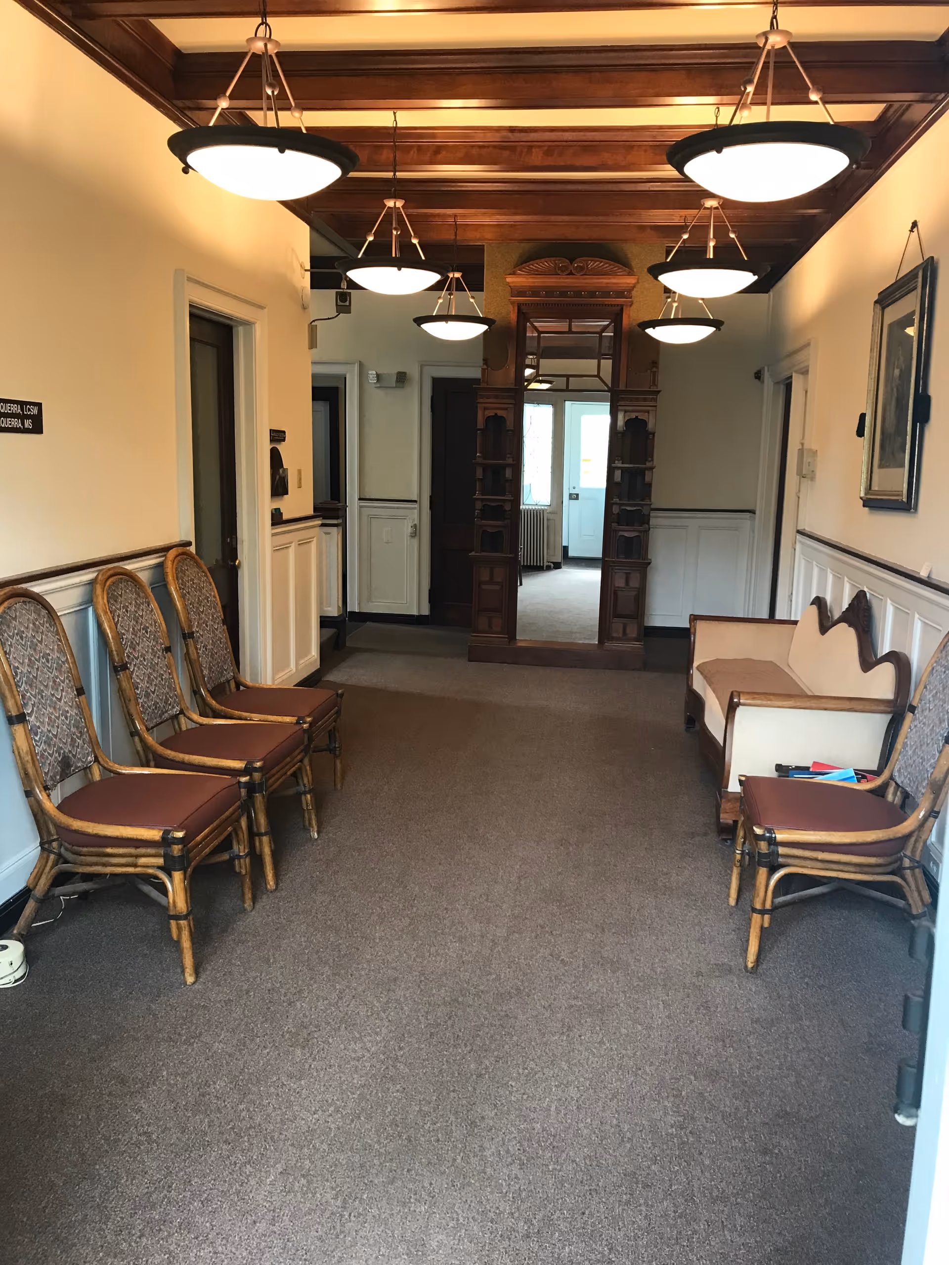 Interior hallway in a senior living facility with seating along the walls.