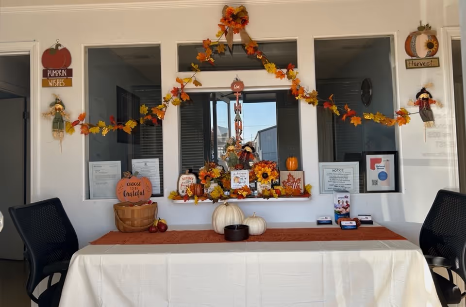 Autumn-themed reception area with pumpkins and garlands in a facility lobby.