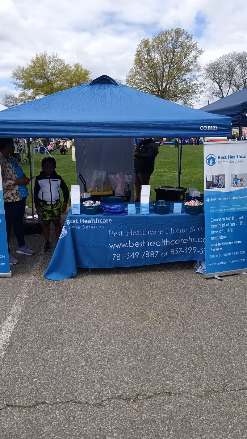 Blue tent booth for Best Healthcare Home Services at an outdoor community event.