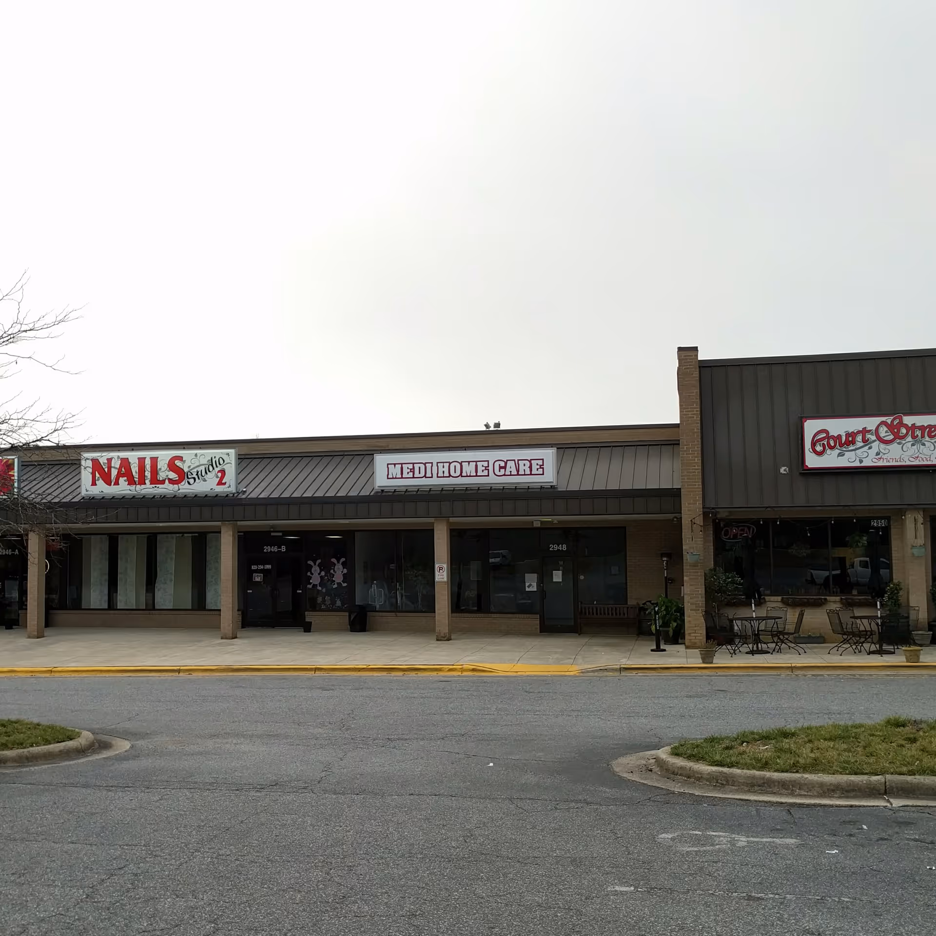 Exterior strip mall storefronts with Medi Home Care sign visible.