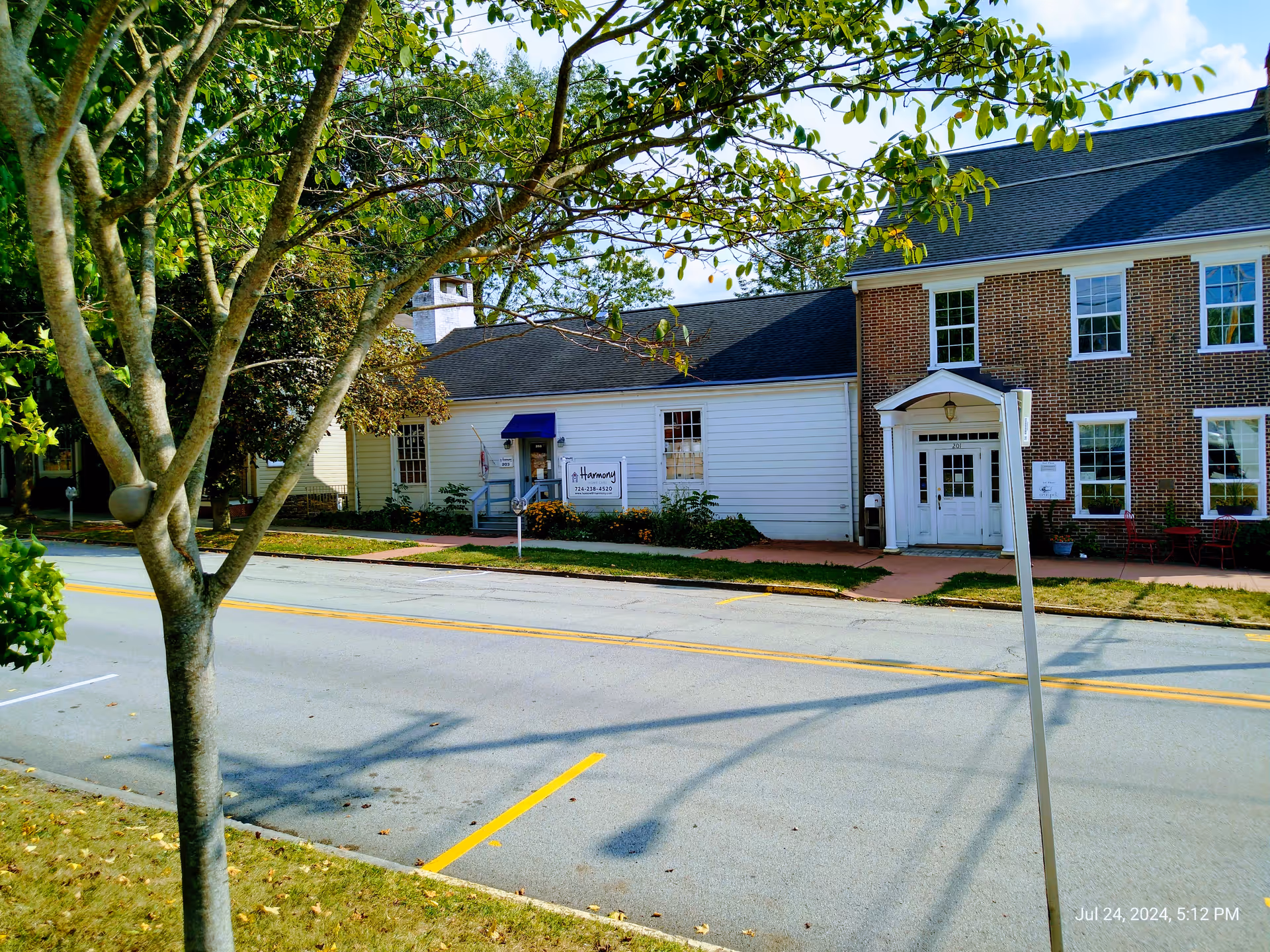 Exterior view of Harmony Home Care building along a street with a sign.