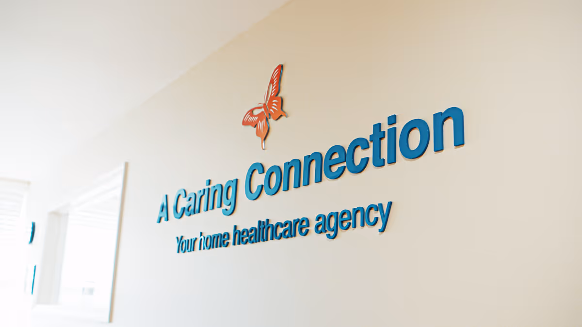 Interior wall displaying A Caring Connection logo with a butterfly graphic.