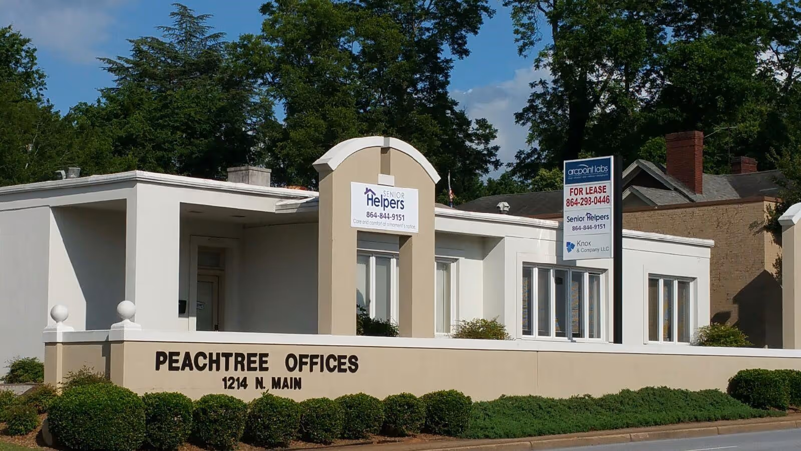 Exterior view of Peachtree Offices building with a Senior Helpers sign on the facade.