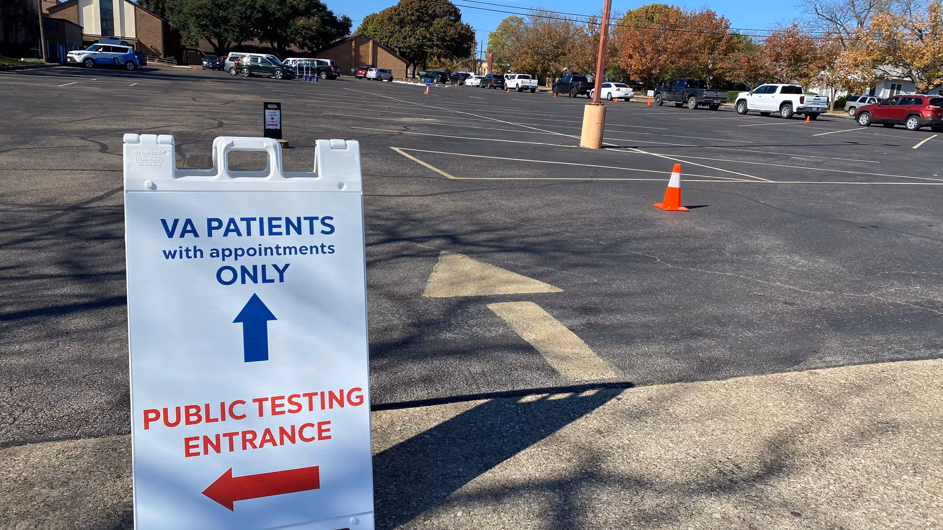 Large white sign in a parking lot directs VA patients to the testing entrance.