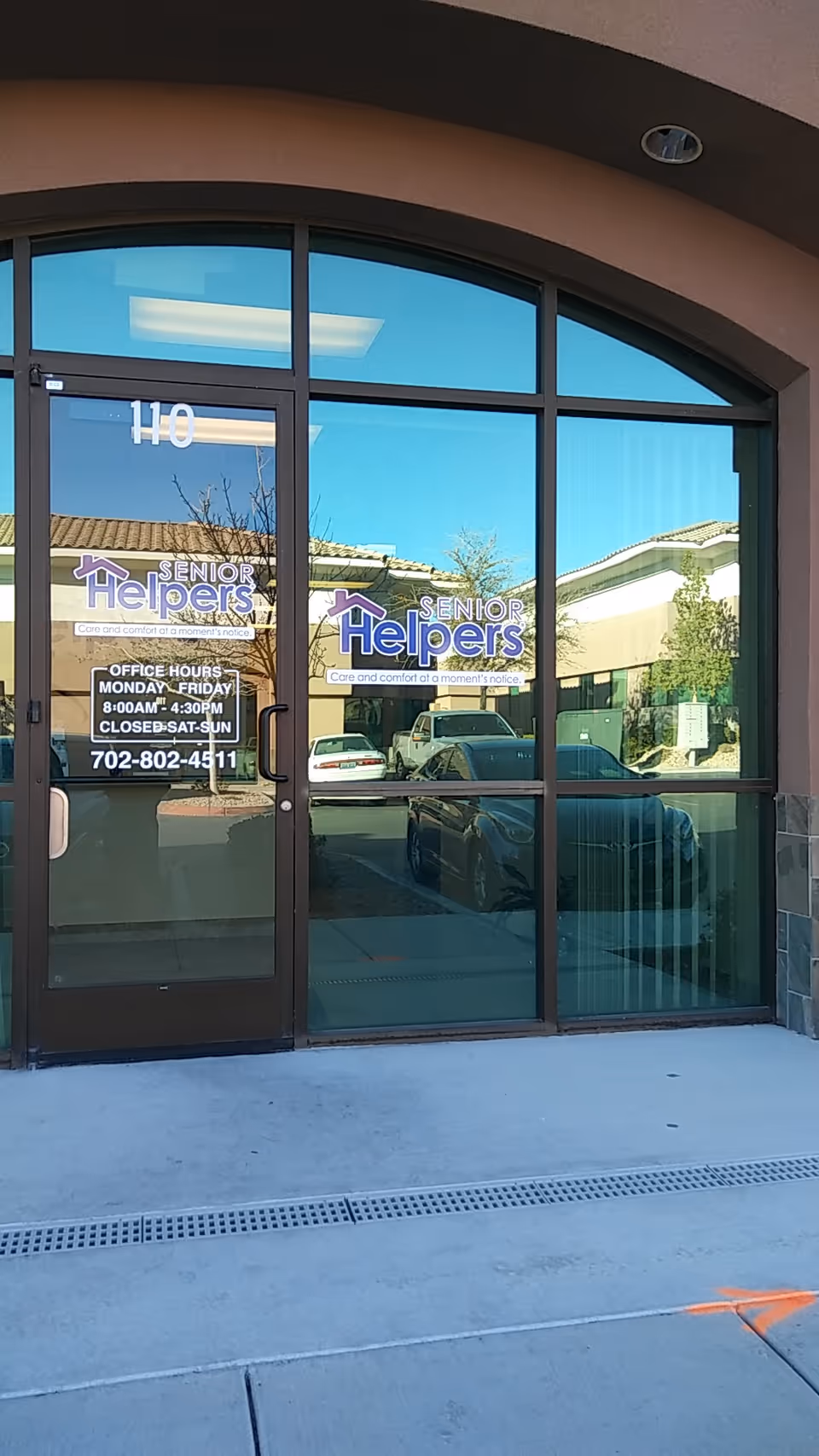 Exterior entrance of a Senior Helpers facility featuring glass doors and logo signage.
