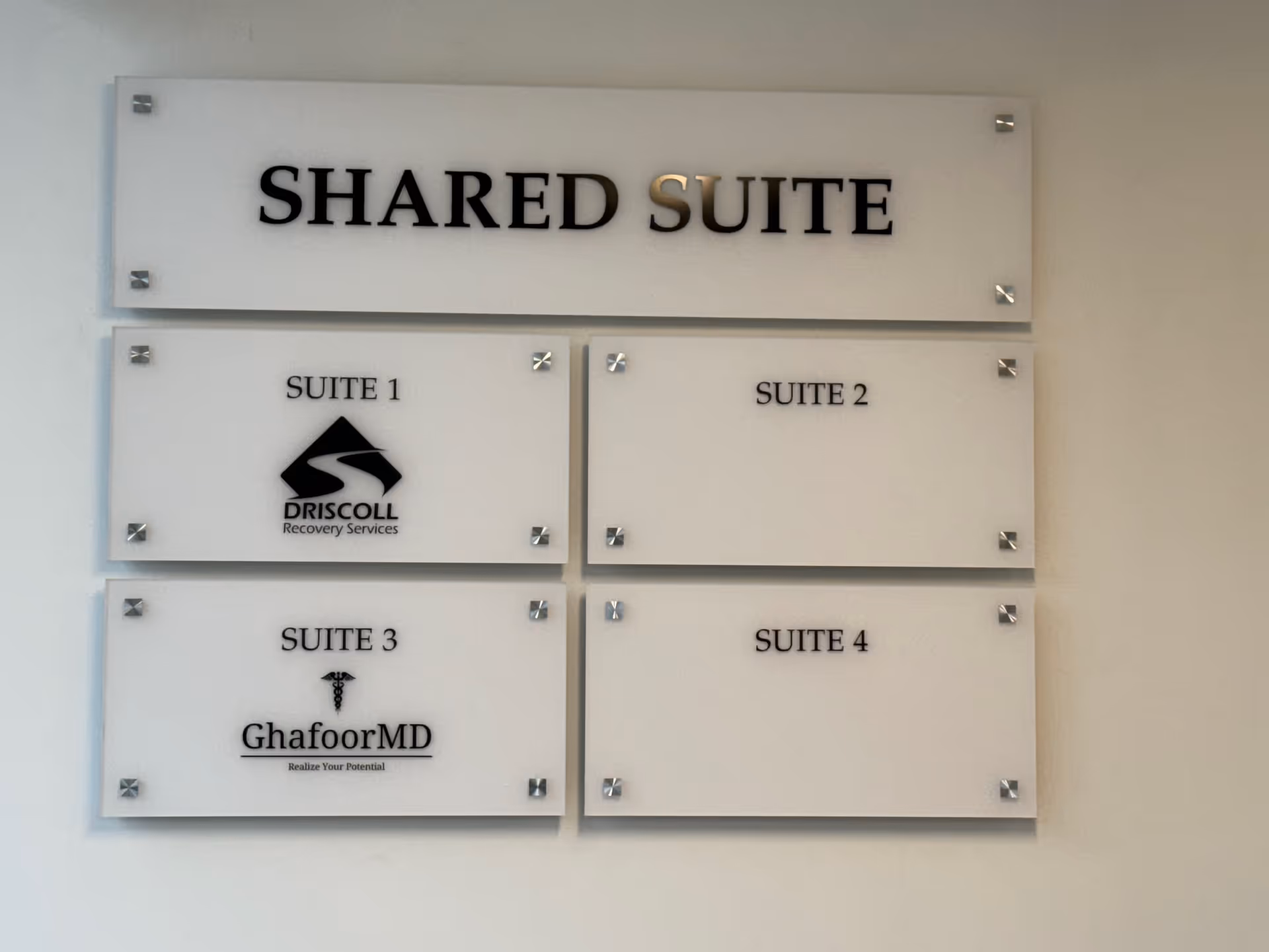 Interior wall signage showing 'SHARED SUITE' and four suite plaques.