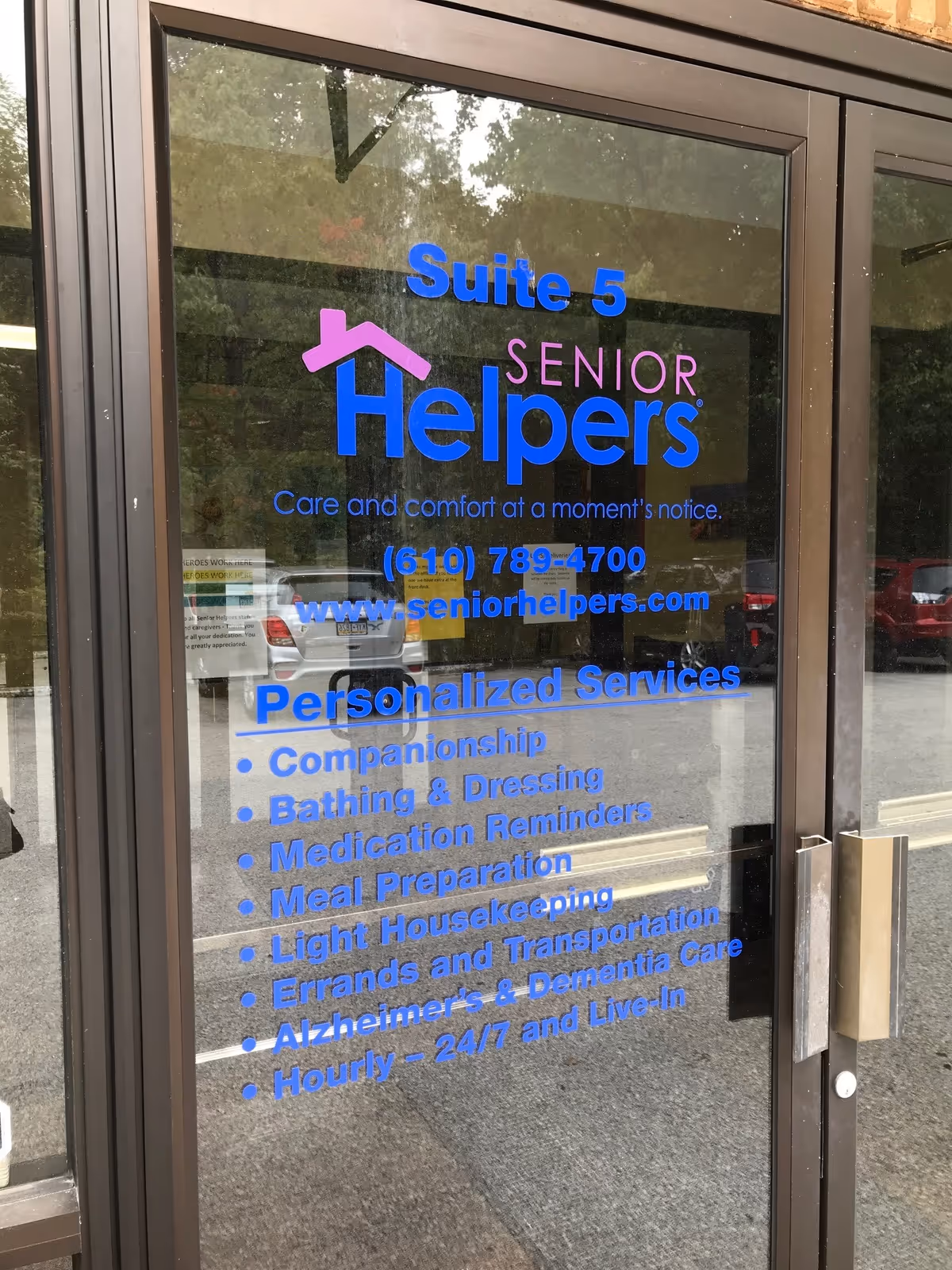 Glass entrance door displaying Suite 5 Senior Helpers and service list.