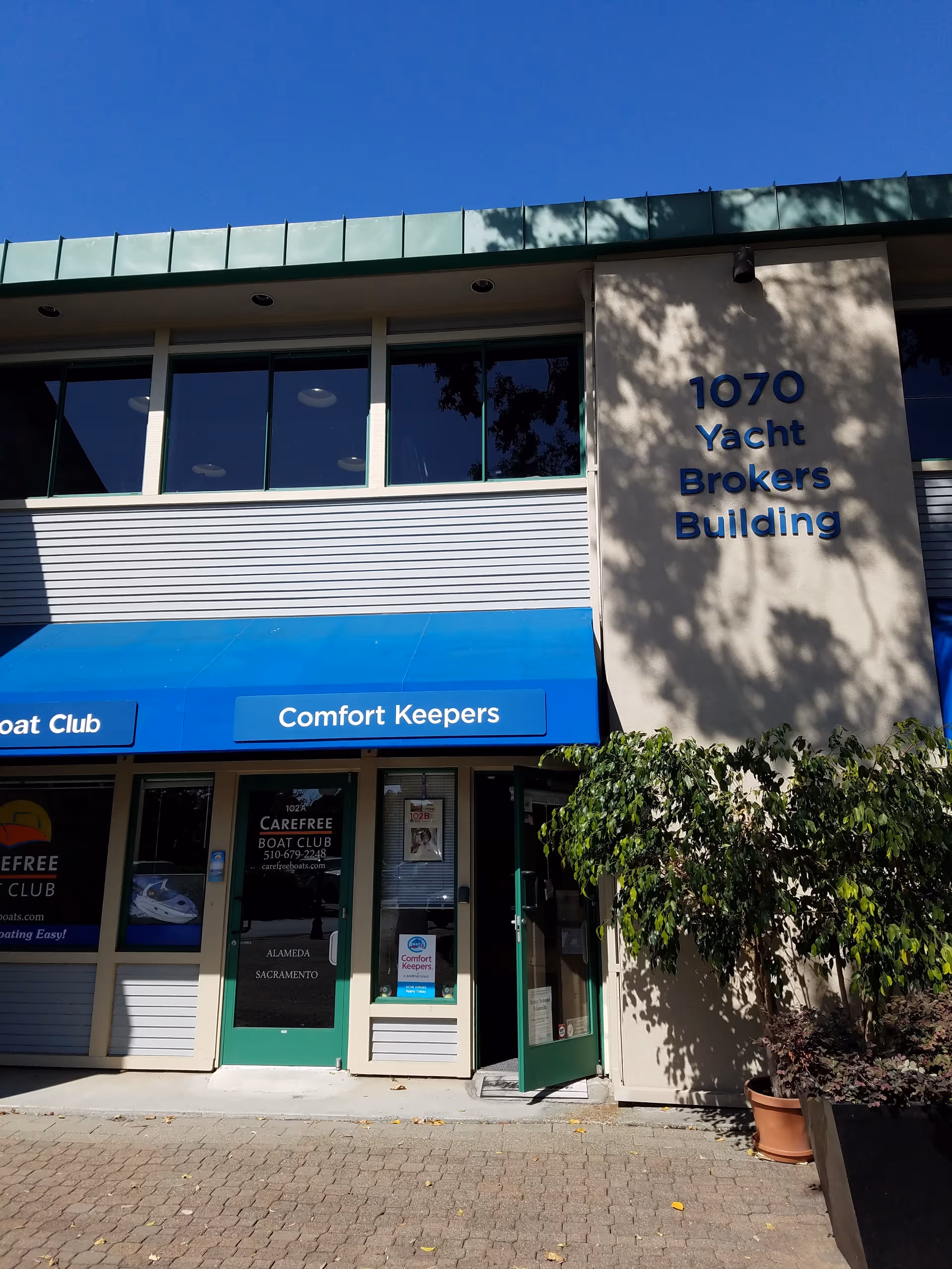 Exterior view of a building with a blue Comfort Keepers storefront sign.