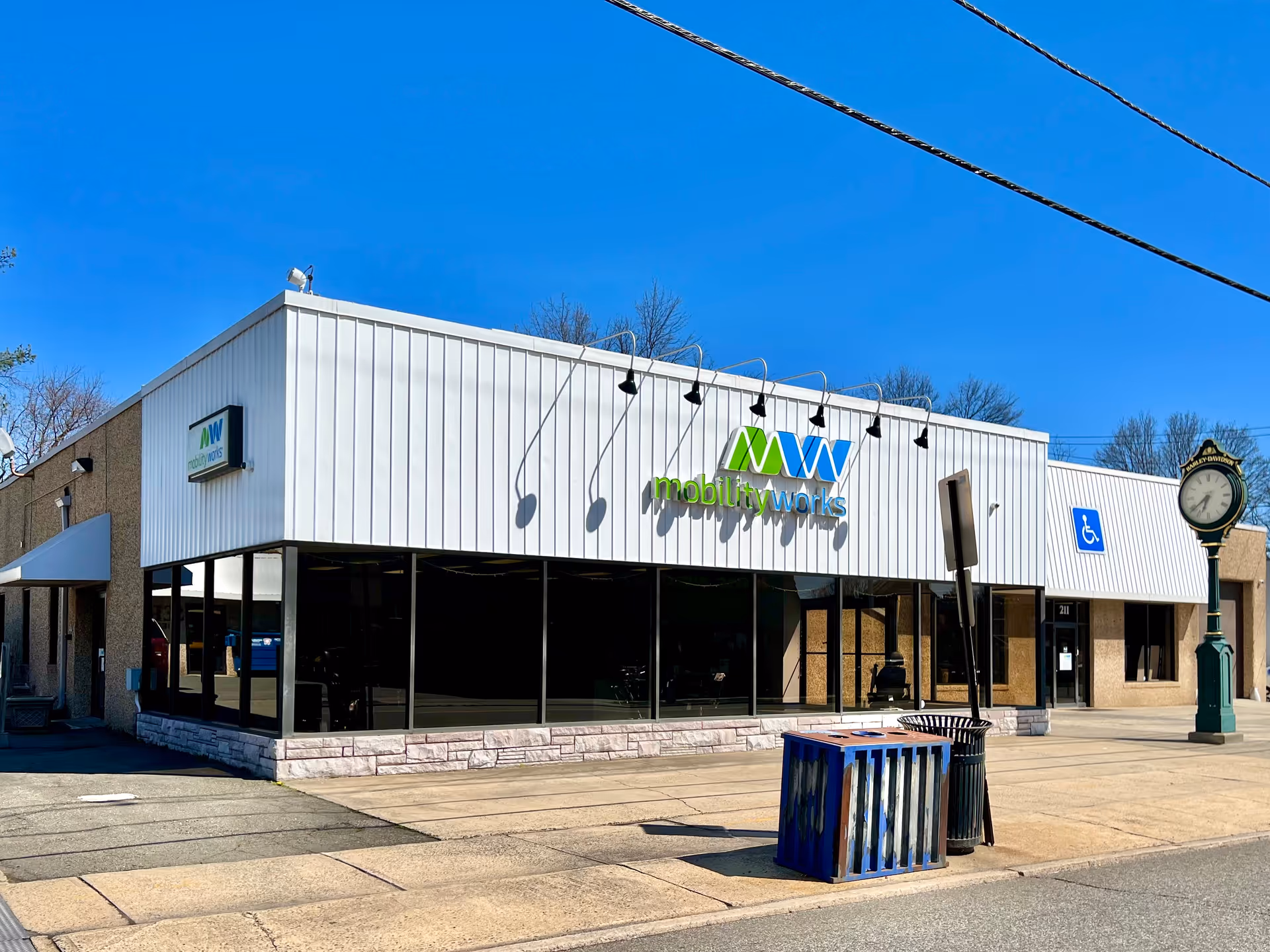 White MobilityWorks storefront with large glass windows and blue sky.