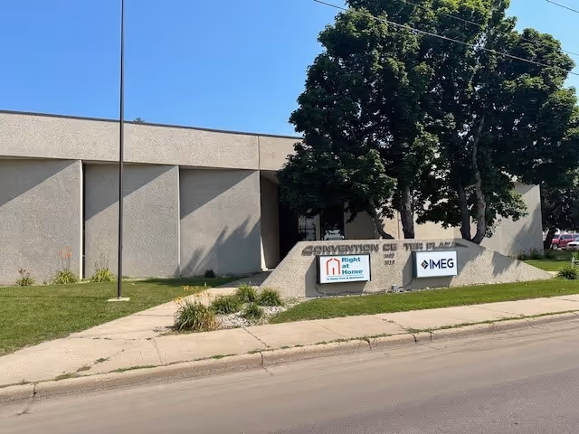 Exterior view of a senior living facility's front entrance with a sign reading Right at Home.