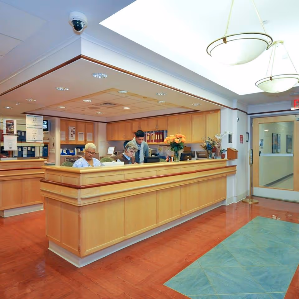 Reception desk with staff assisting visitors in a Calvary Hospital lobby