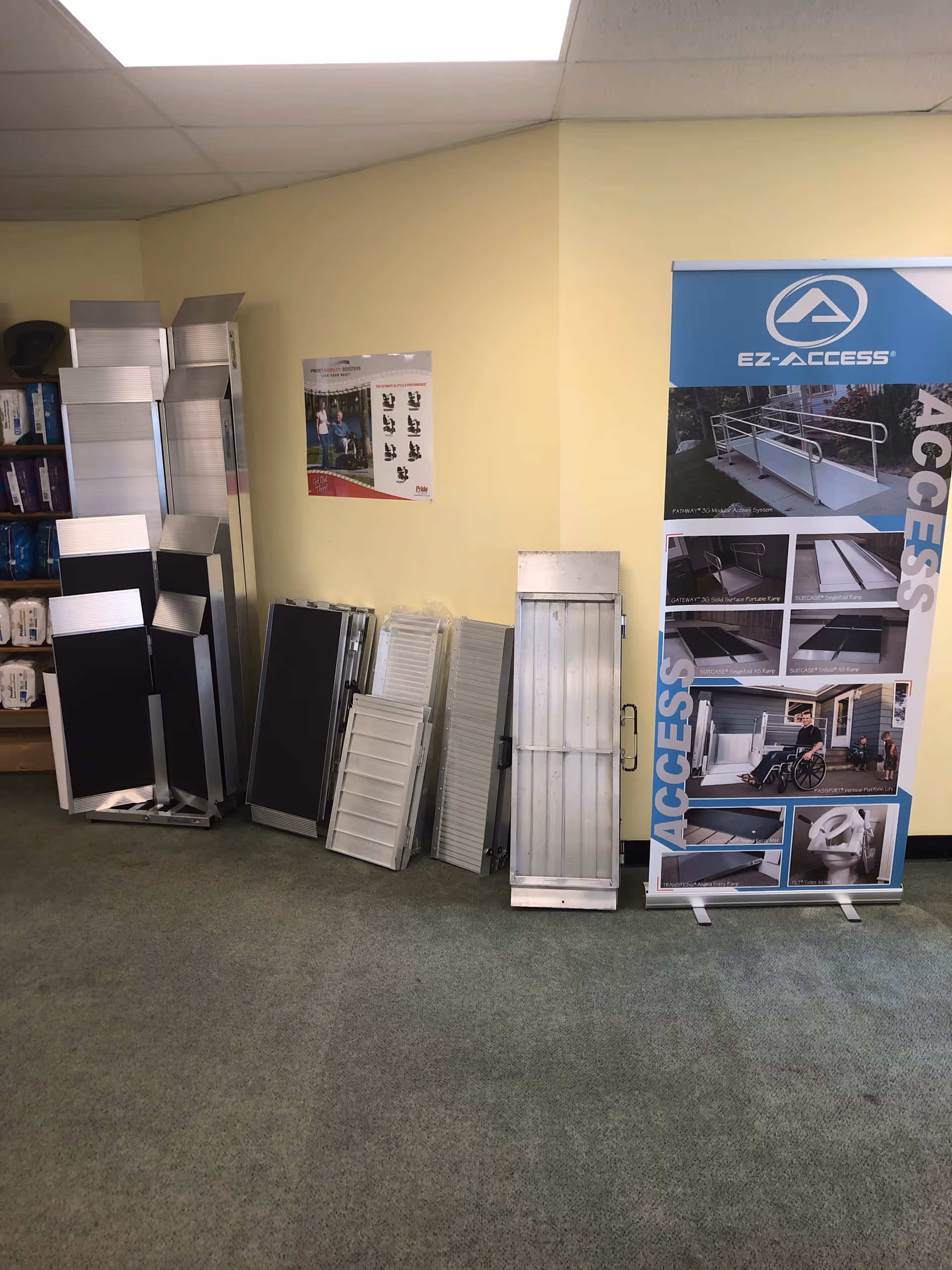 Indoor showroom area with metal accessibility ramps and a large EZ-ACCESS banner