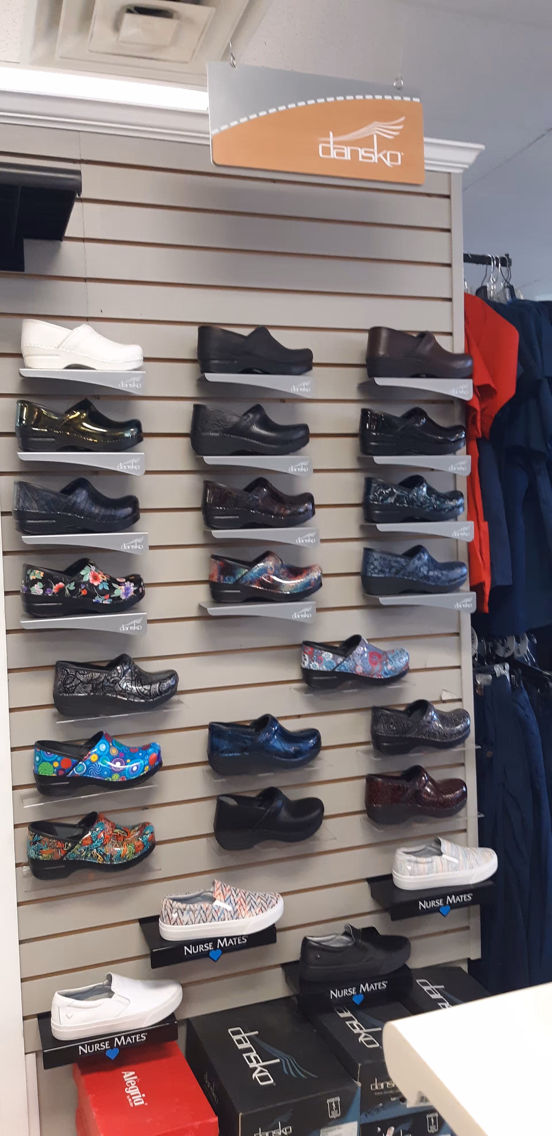 Interior display of nurse shoes on wall-mounted racks.