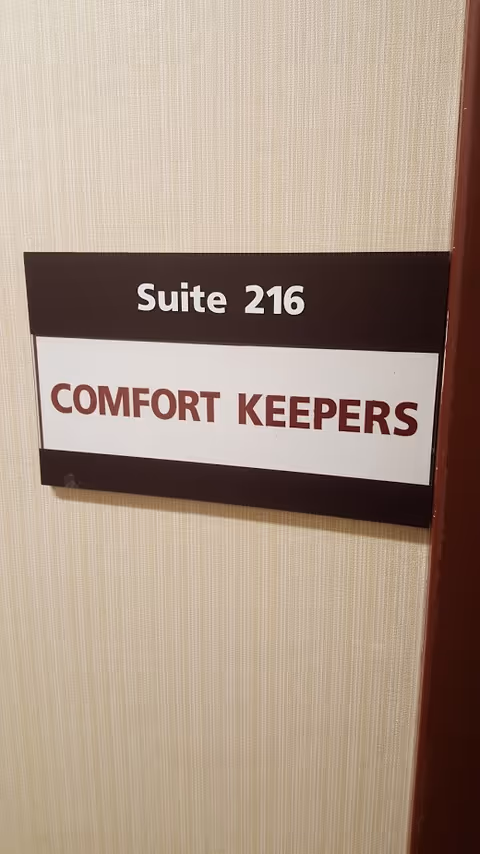 Interior wall sign reads Suite 216 and Comfort Keepers in hallway.