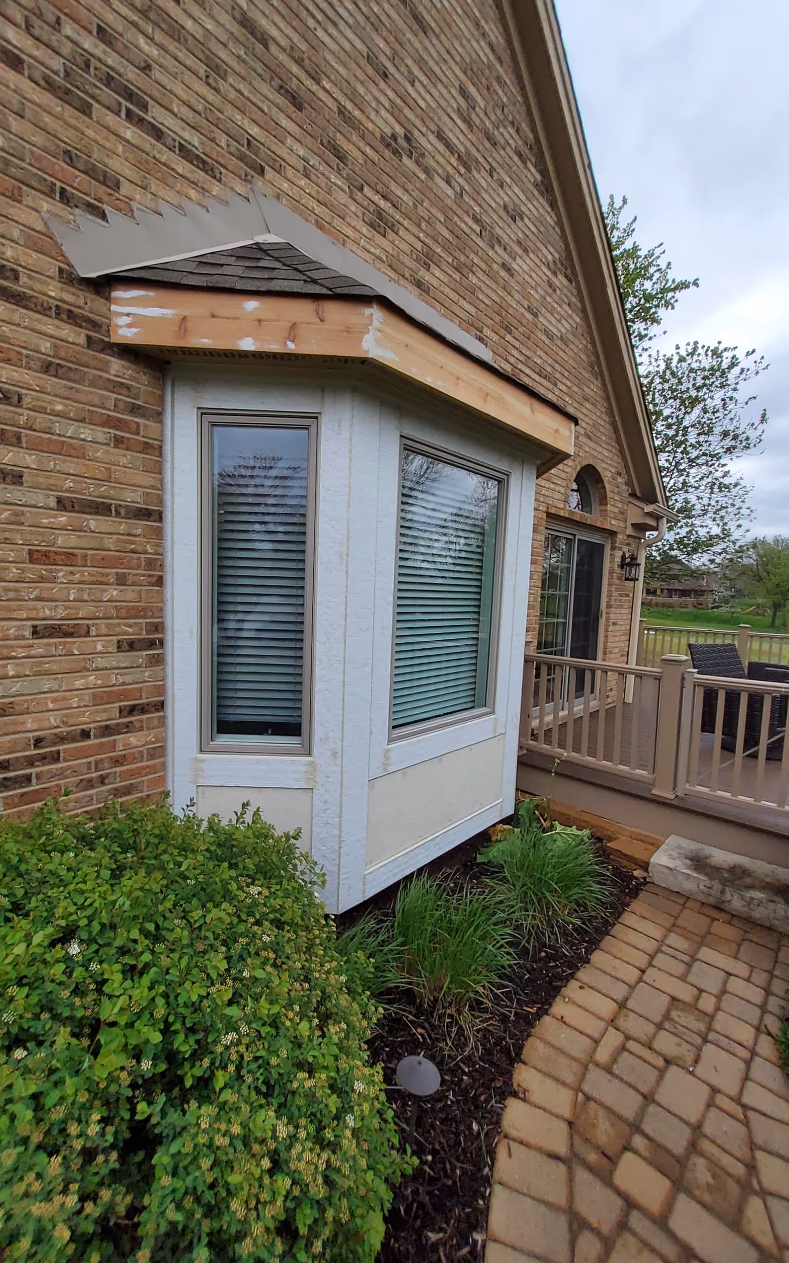 Brick exterior view of Elderly Care facility with bay window and deck.