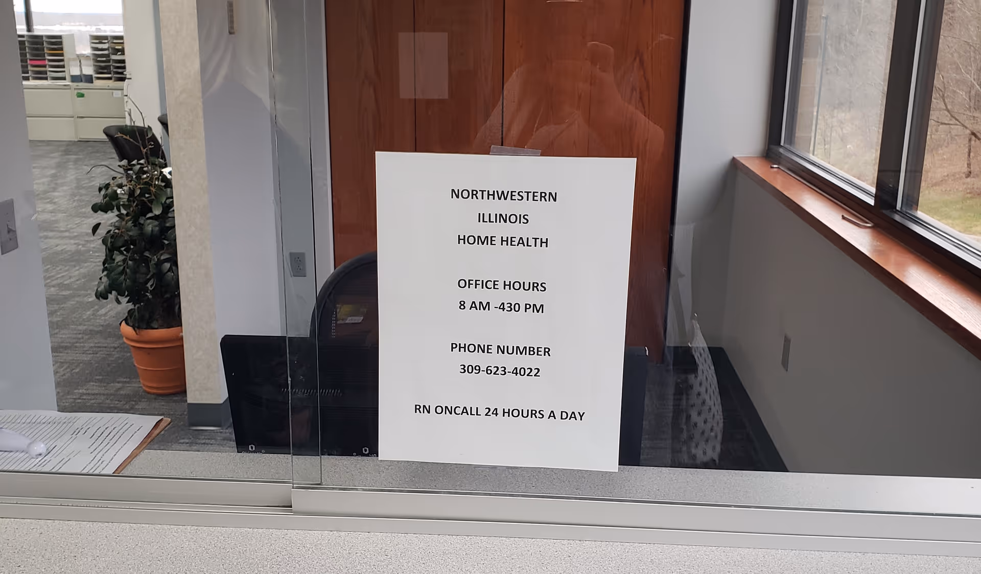 Interior reception area with glass wall sign reading Northwestern Illinois Home Health