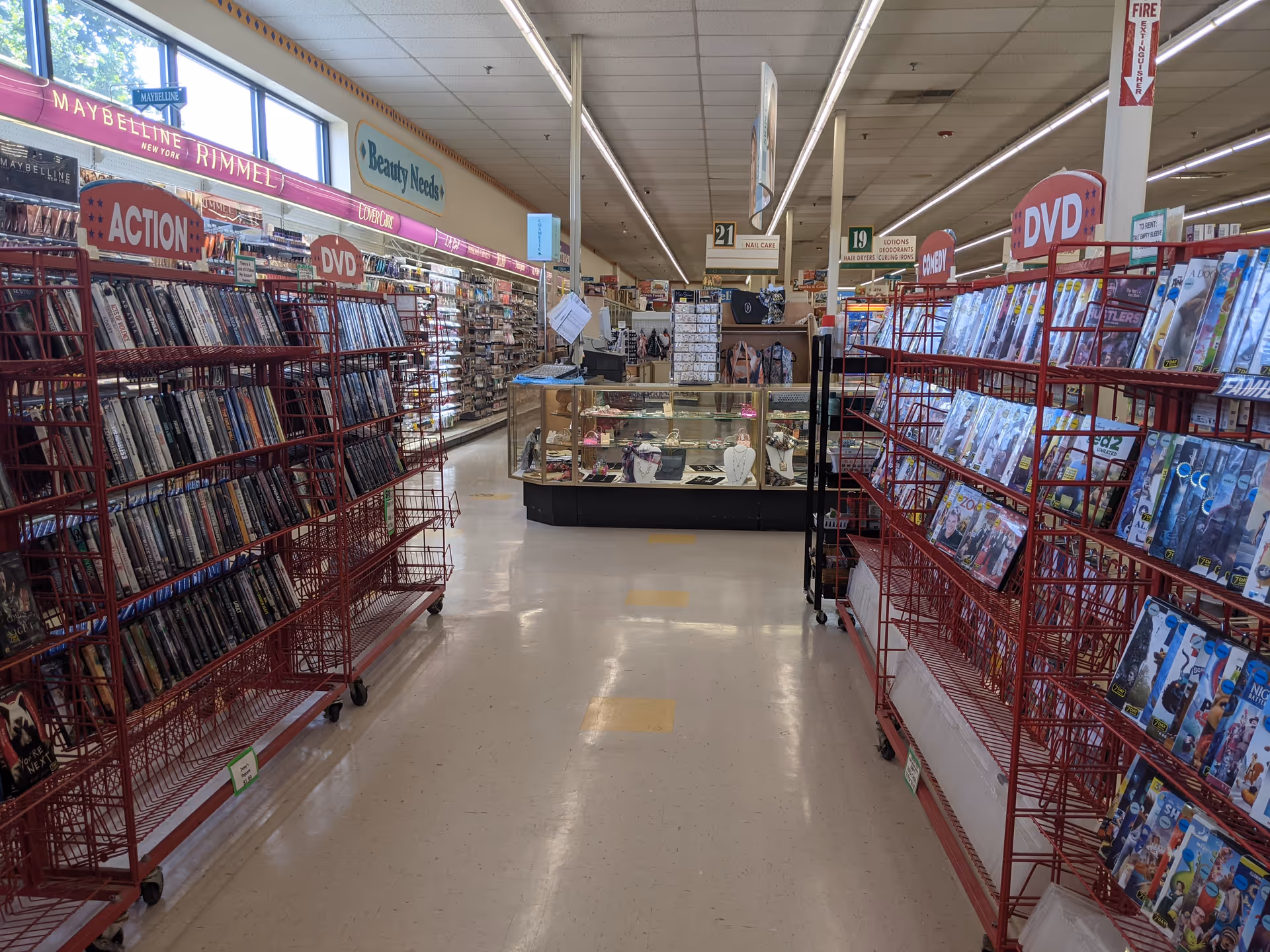 Interior of Discount Drug Mart with long aisles and red magazine racks.