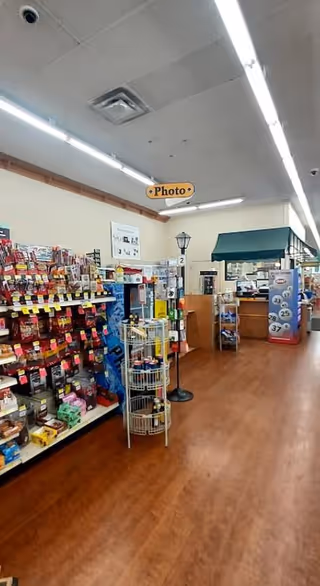 Indoor Discount Drug Mart aisle with shelves, merchandise, and checkout area.