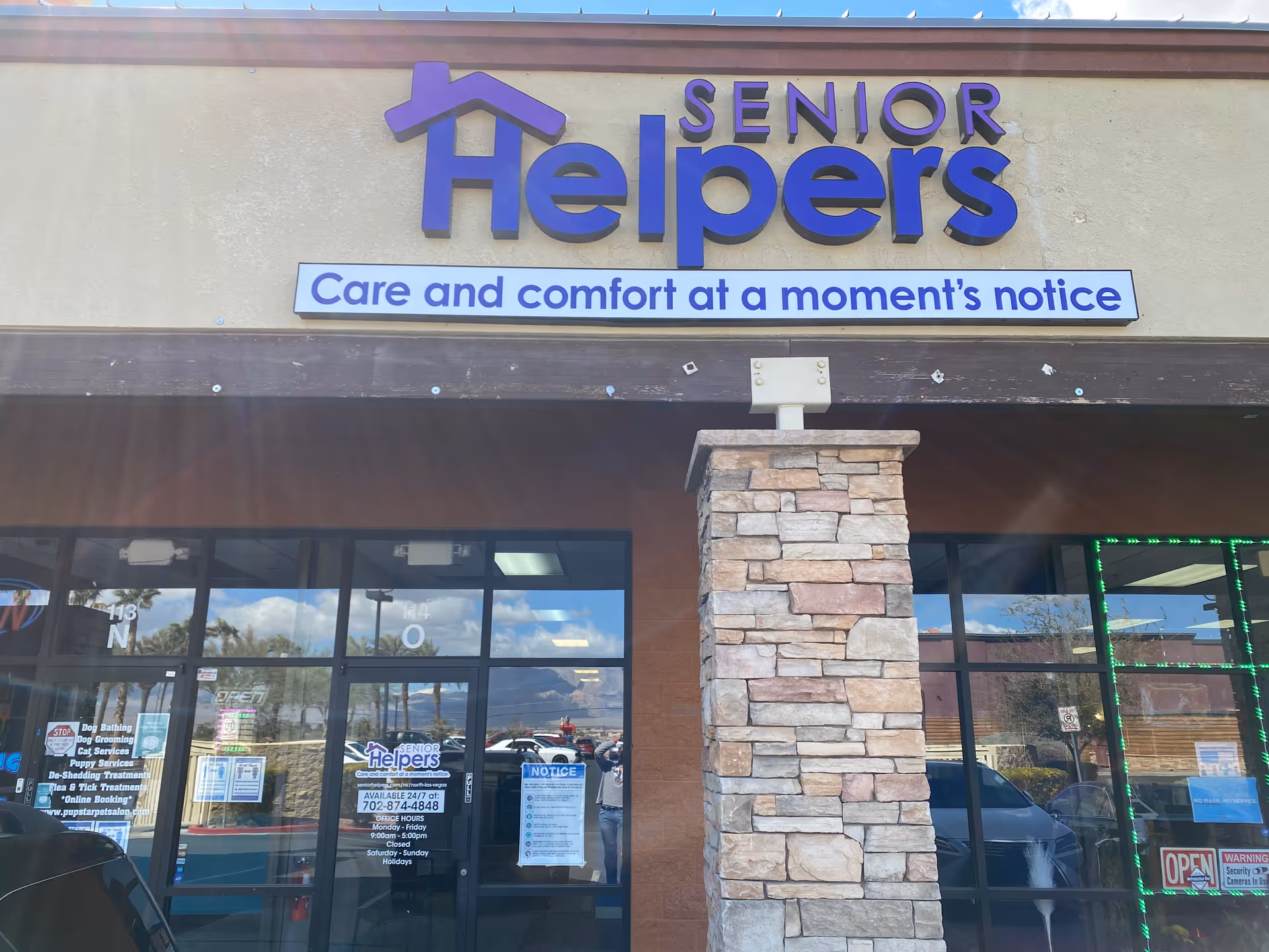 Senior Helpers storefront with large purple sign and stone pillar at entrance.