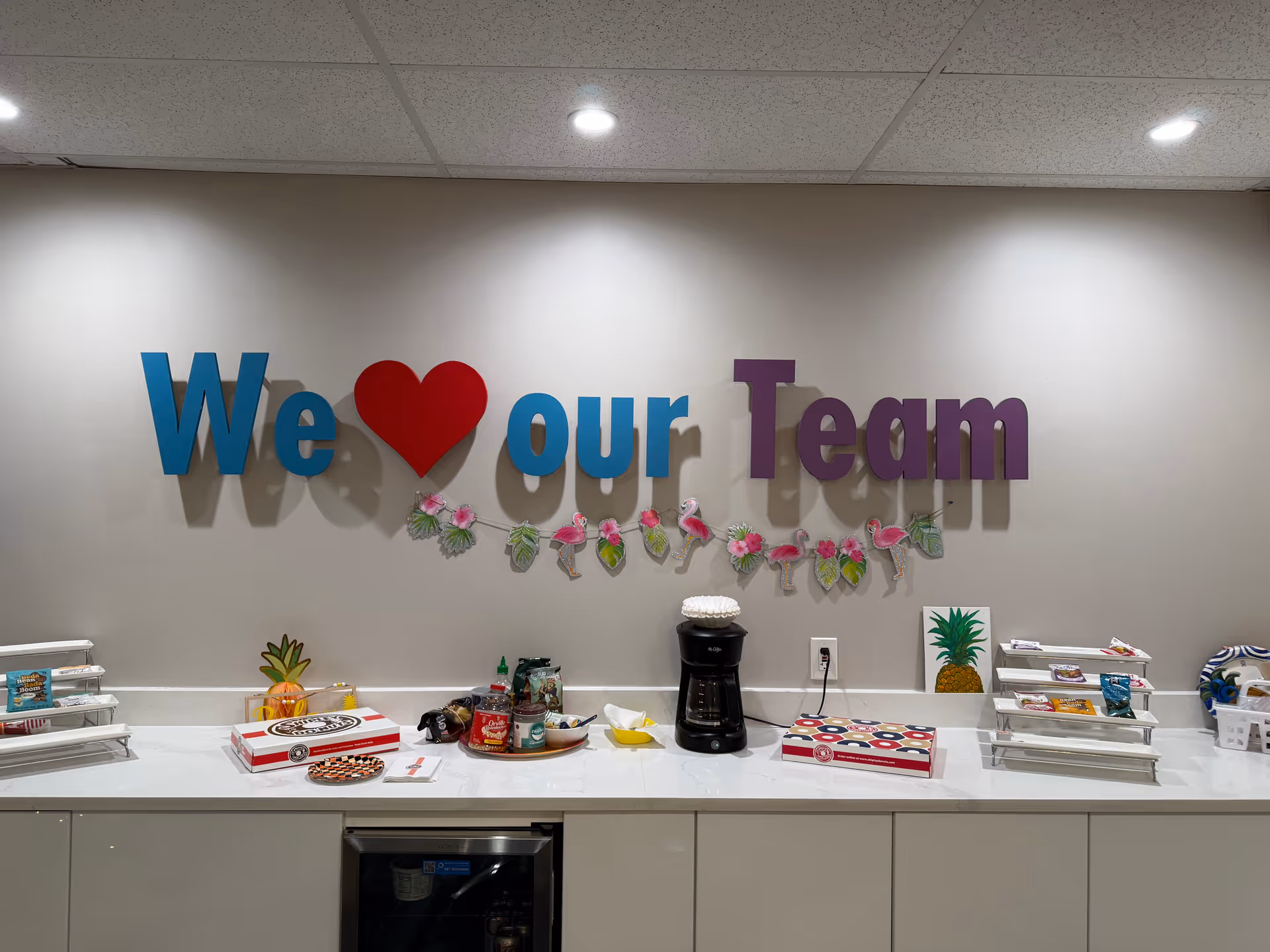 Interior break area featuring a We heart our Team sign and a snack bar