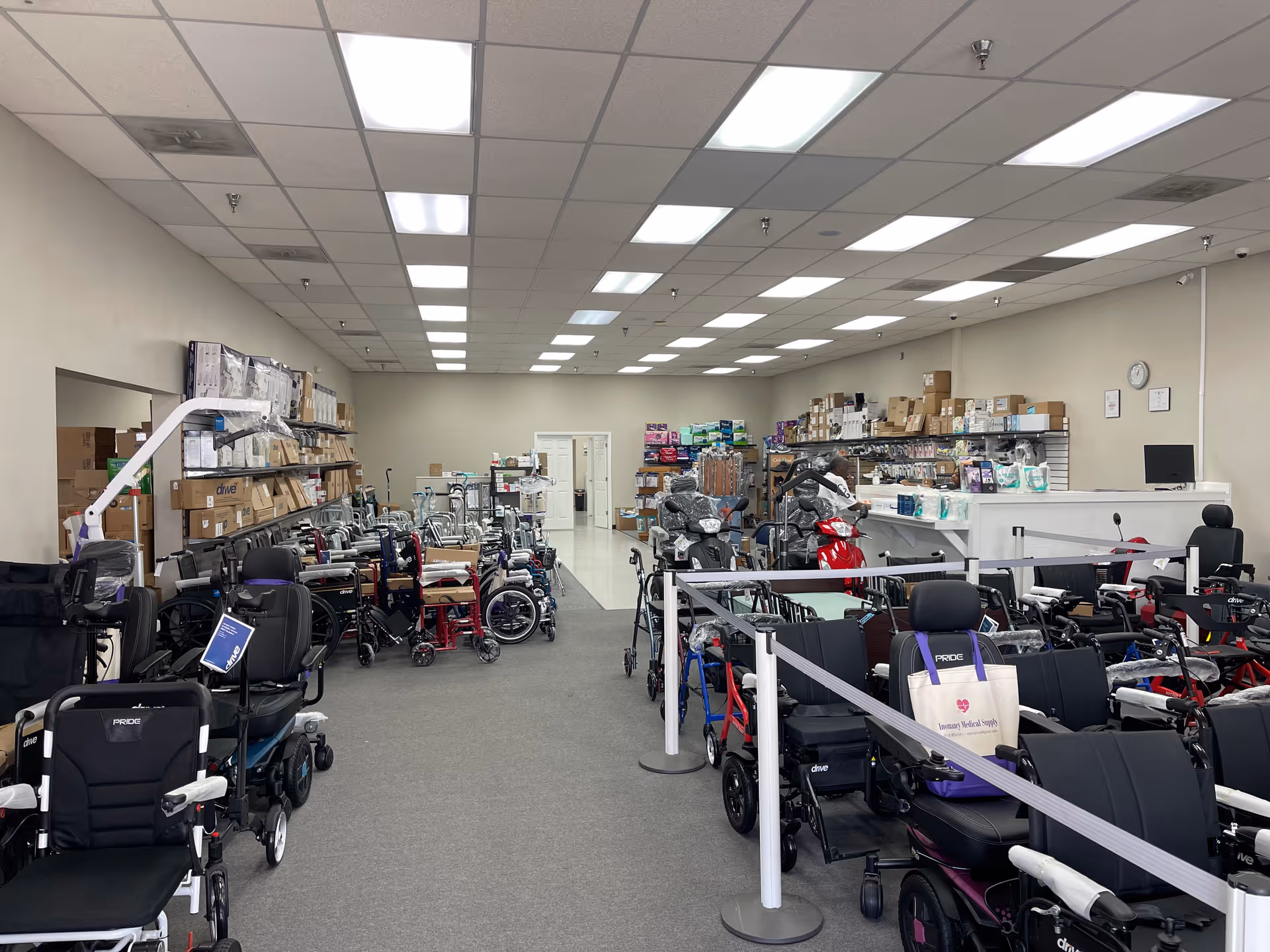 A spacious interior showroom filled with wheelchairs, walkers, scooters, and medical supply shelves.