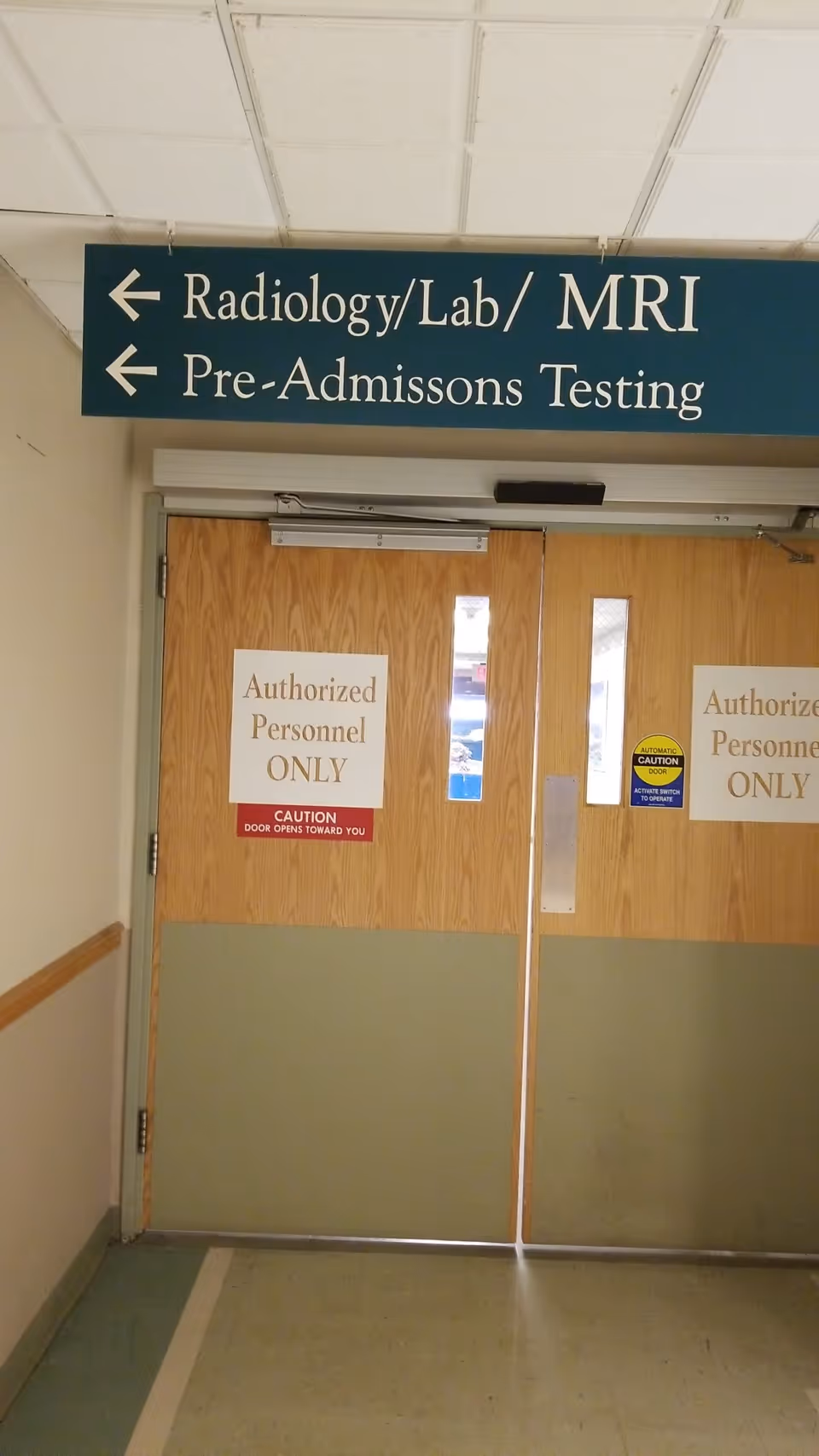 Interior hallway with double doors and signs for Radiology, Lab, MRI, and Pre-Admissions Testing.