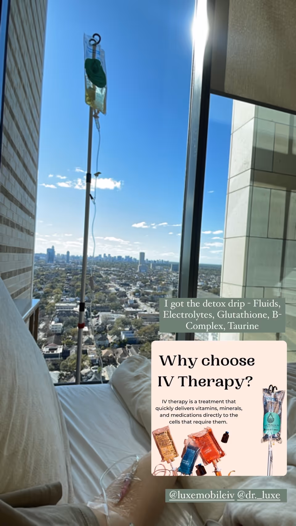 IV drip stand beside couch, city skyline visible through large window