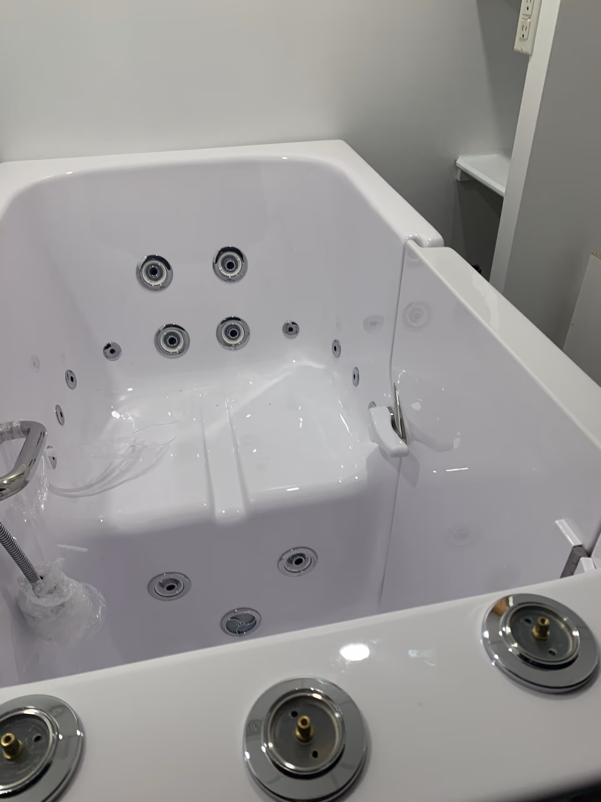 White hydrotherapy whirlpool tub with jets in a modern bathroom.