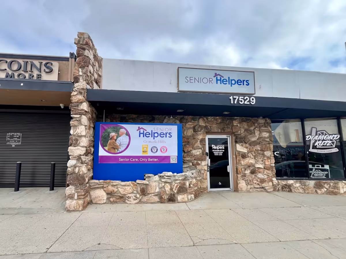 Exterior storefront of Senior Helpers with stone facade and entrance door.