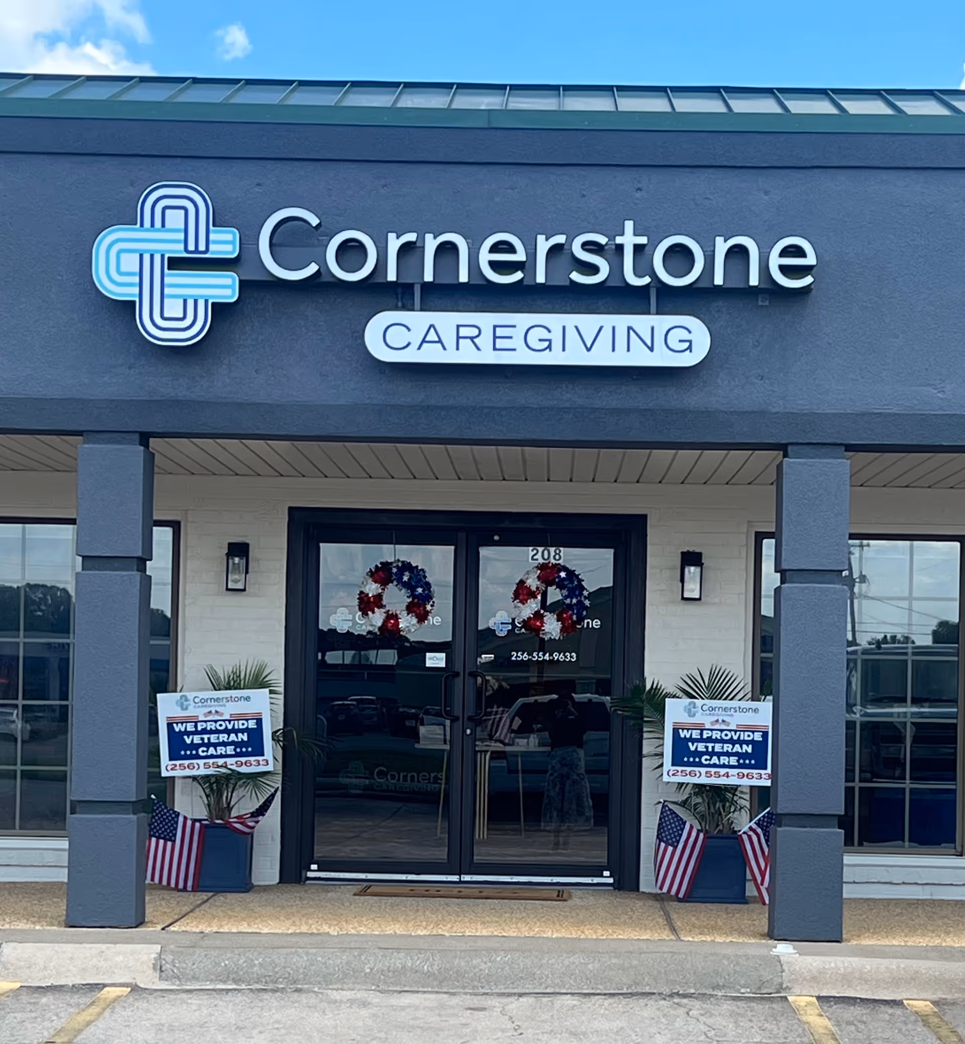 Cornerstone Caregiving building front with double doors, wreaths, and patriotic decor.