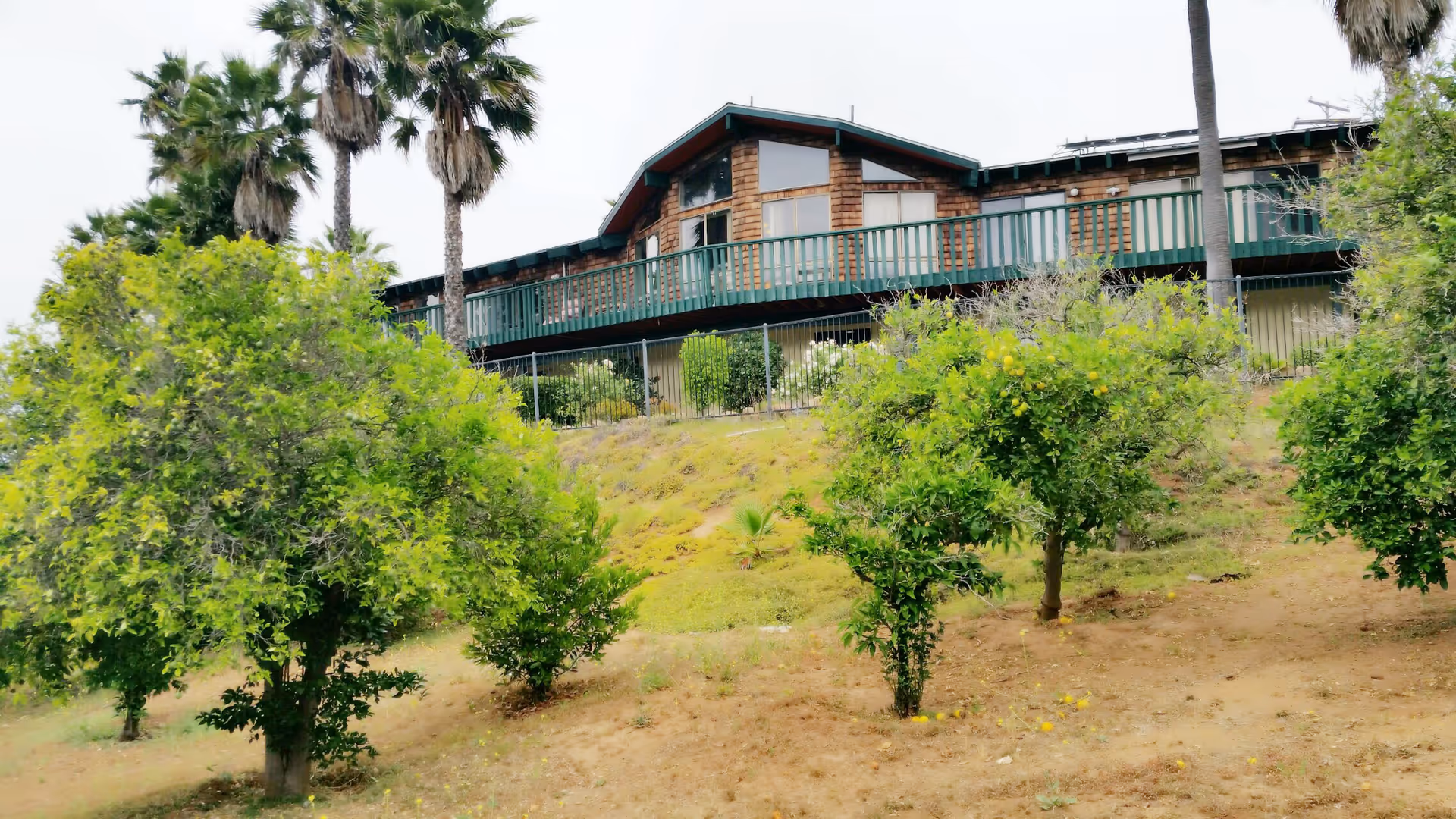 Mountain View Manor Assisted Living sits on a hillside with a long balcony.