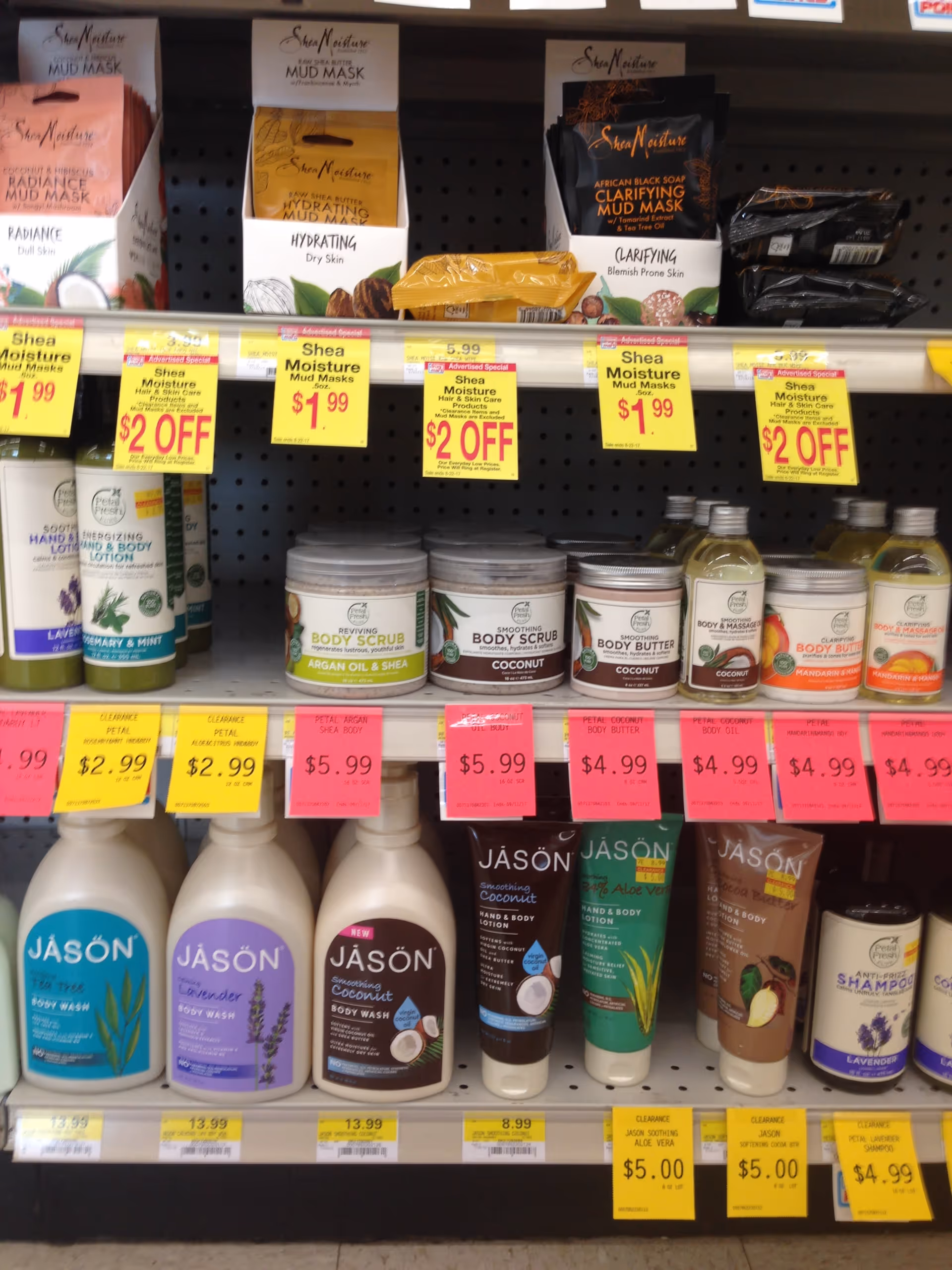 Store shelf displays assorted skincare products with bright yellow price tags.