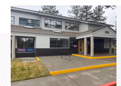 Exterior view of a Senior Helpers facility with entrance, signage, and bike rack.