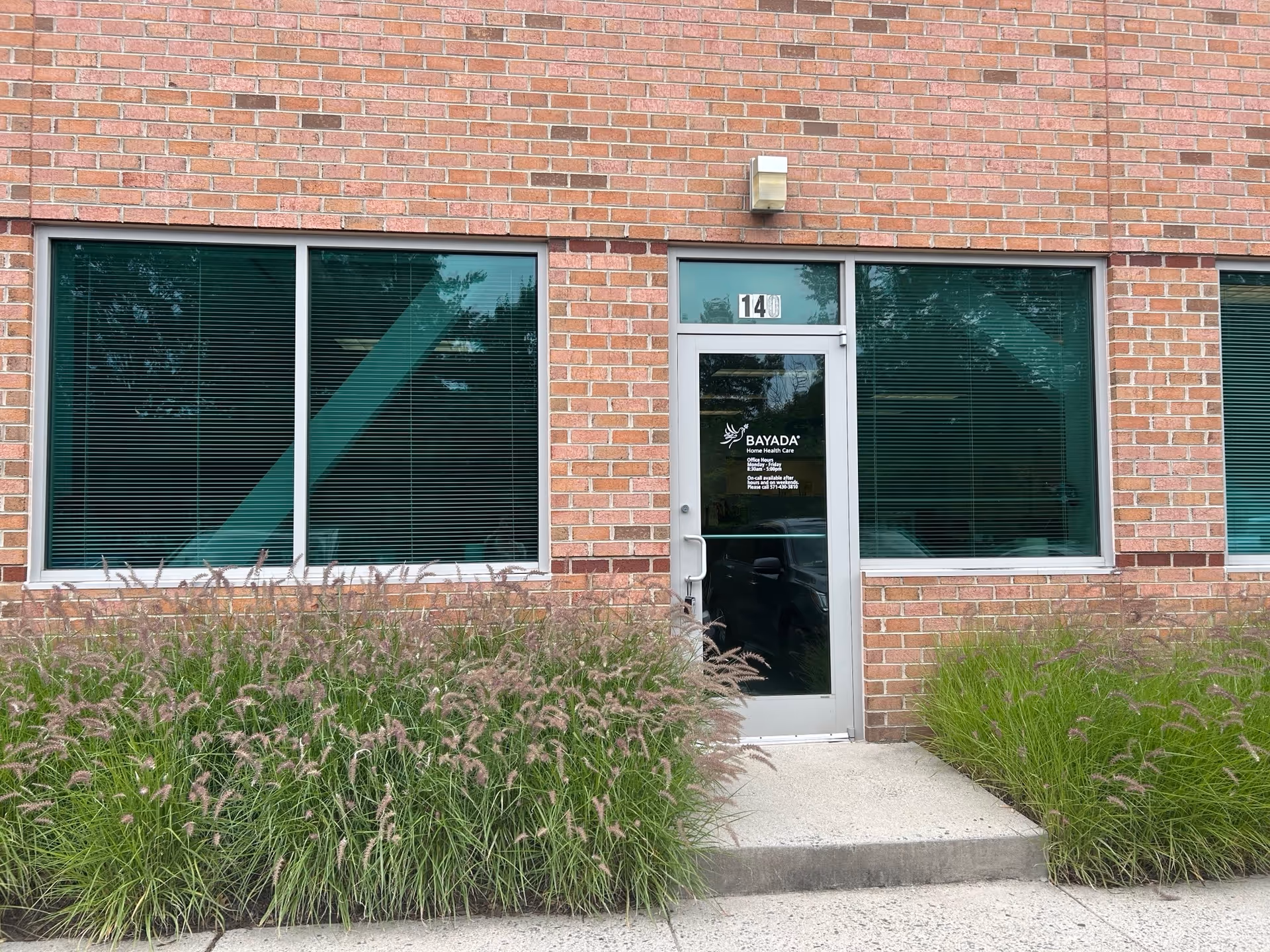Brick building exterior shows BAYADA Home Health Care entrance with green landscaping.