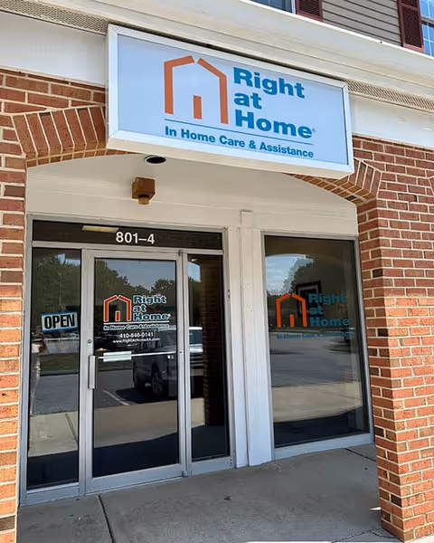 Brick building entrance with Right at Home sign and glass doors