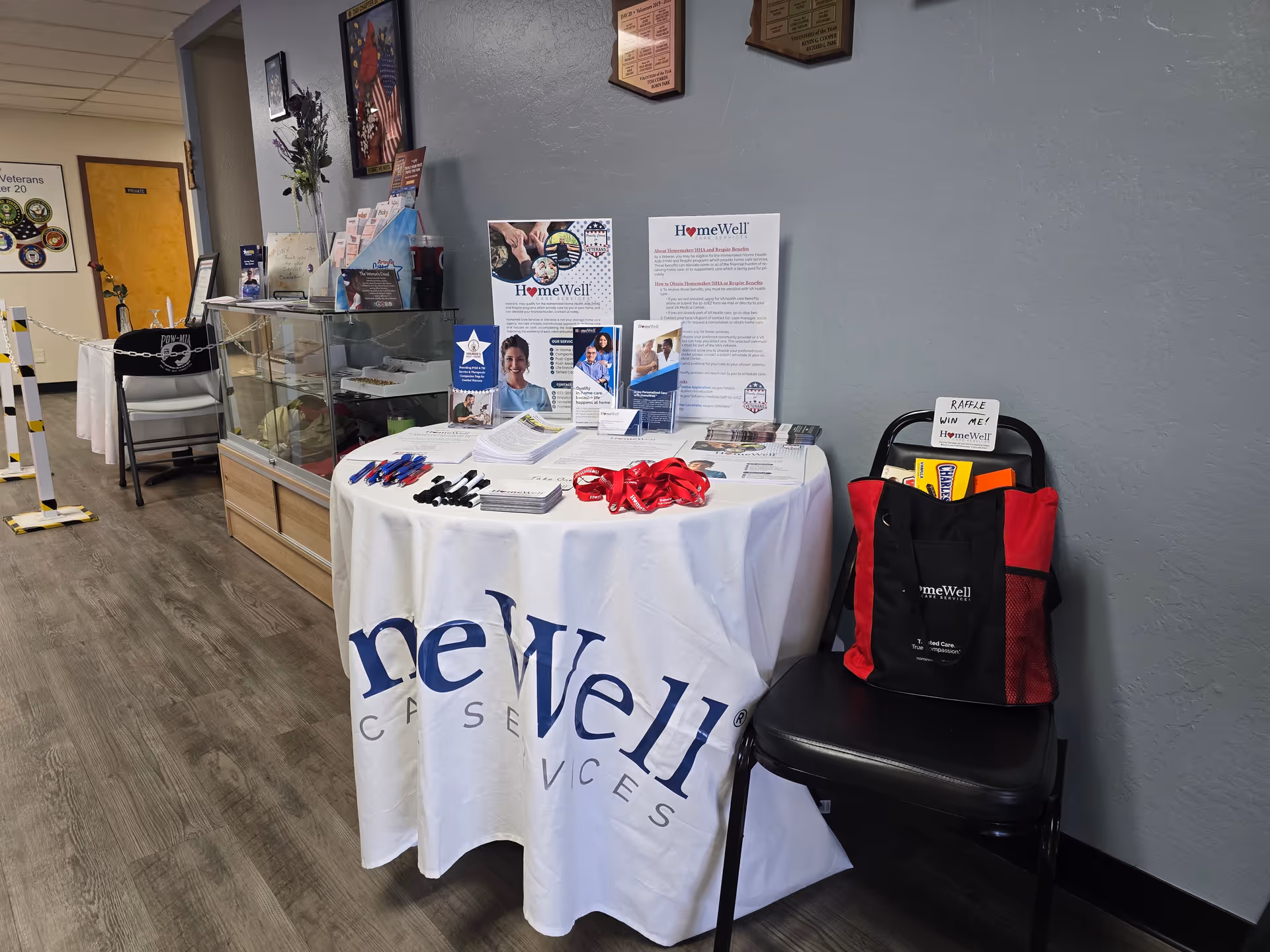 Indoor reception area featuring a round brochure table and HomeWell display materials.