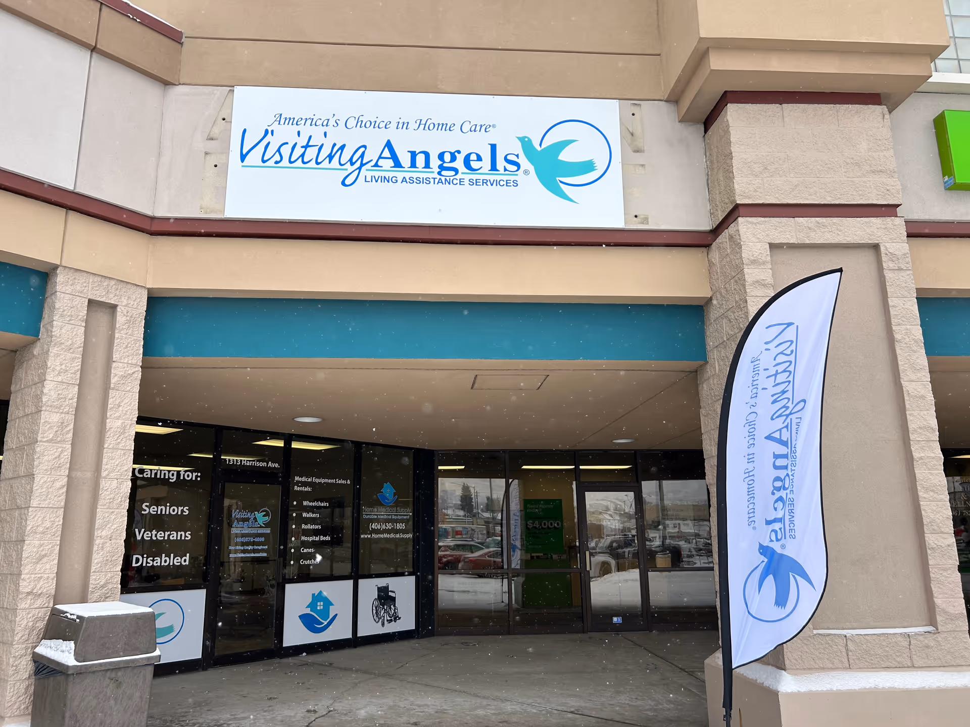 Storefront of Visiting Angels Senior Home Care with entrance, sign and banner.