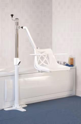A white accessibility bathtub chair with a lift device in a tiled bathroom.