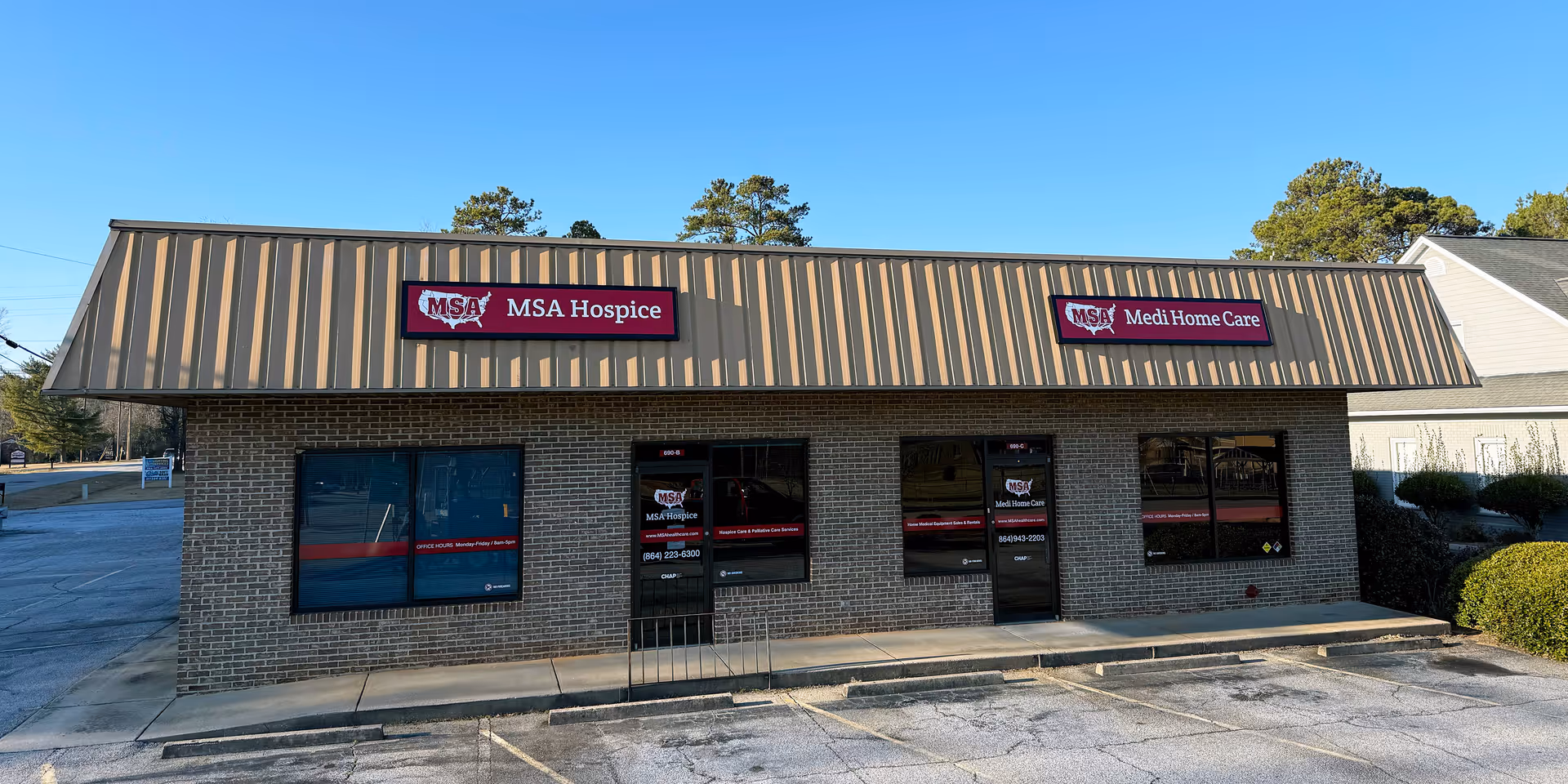 Brick storefront with metal roof shows MSA Hospice and Medi Home Care signs.