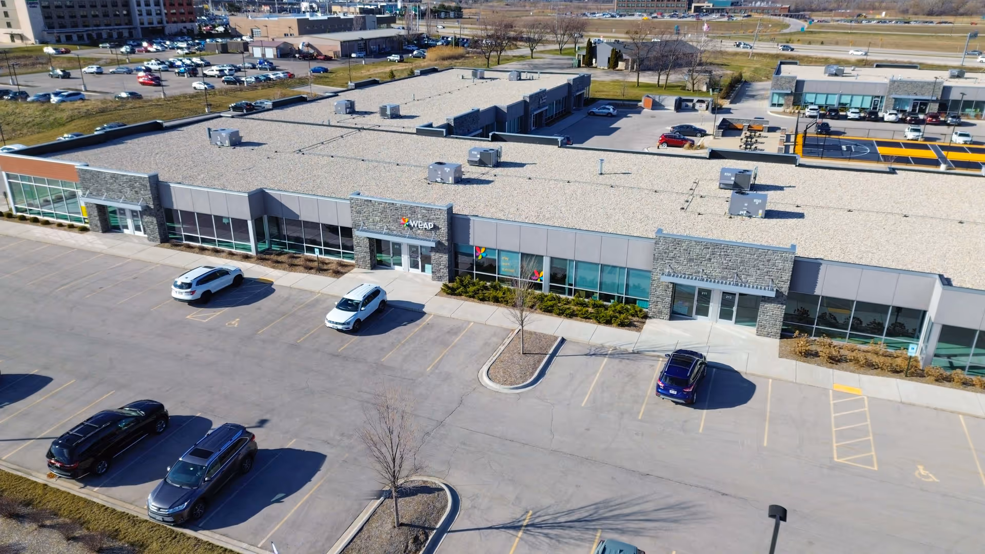 Aerial view of a WEAP facility exterior with parking lot and surrounding area.
