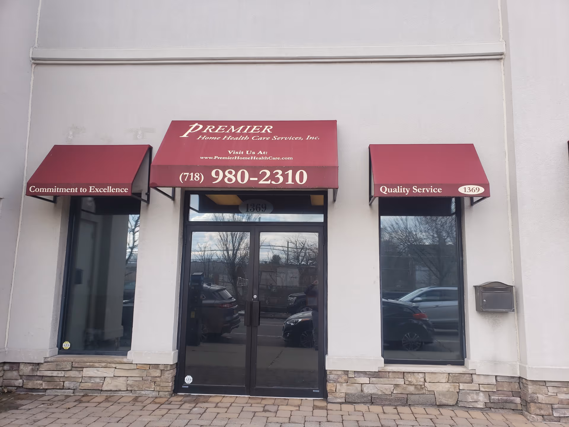 This is the storefront entrance for Premier Home Health Care Services with maroon awnings.