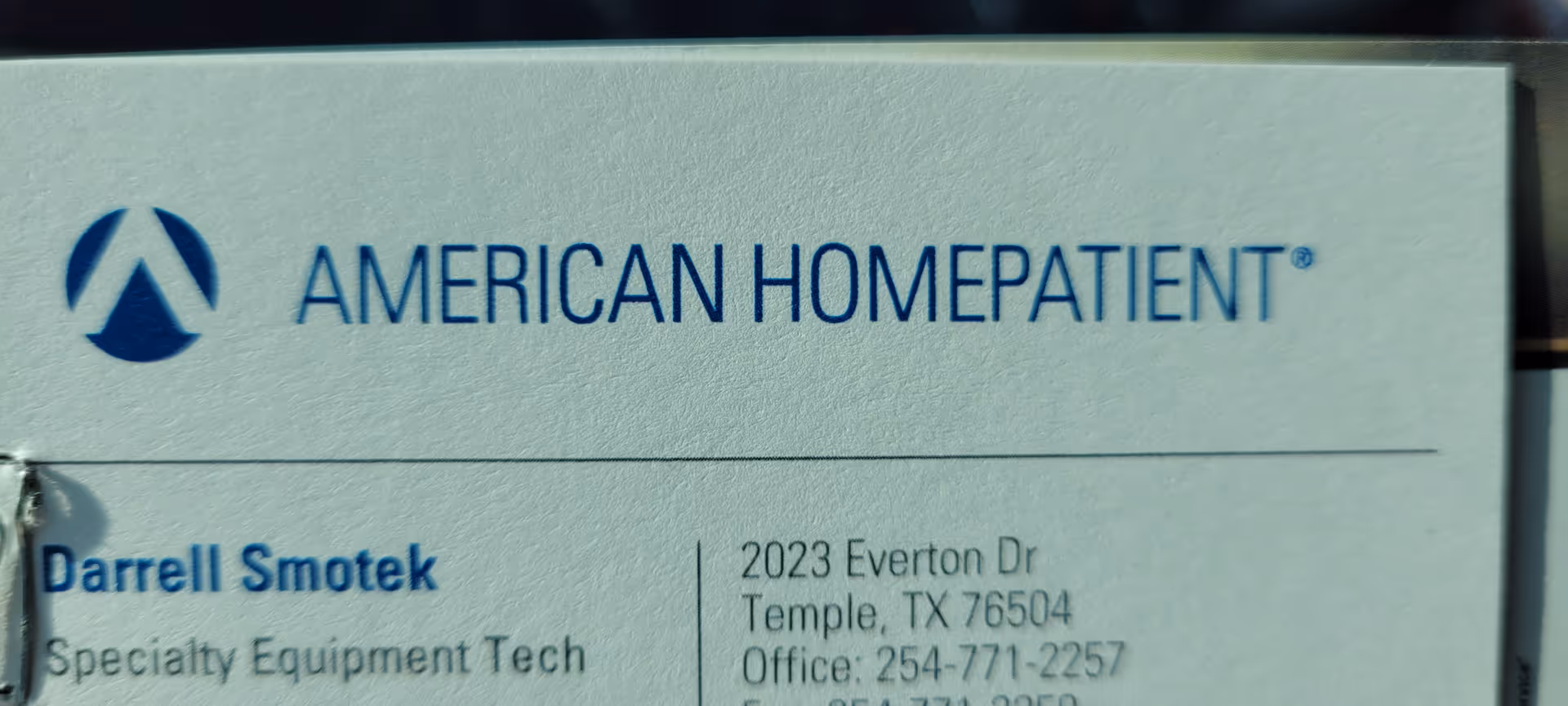 Close-up of a sign reading American HomePatient with address details.