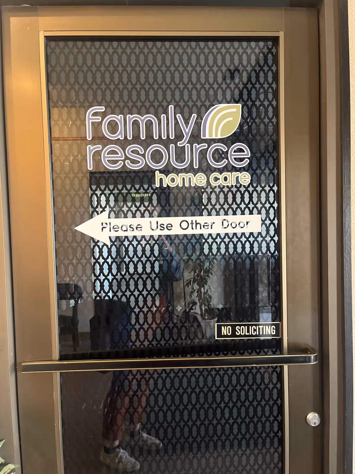 Glass door displaying Family Resource Home Care signage and Please Use Other Door message