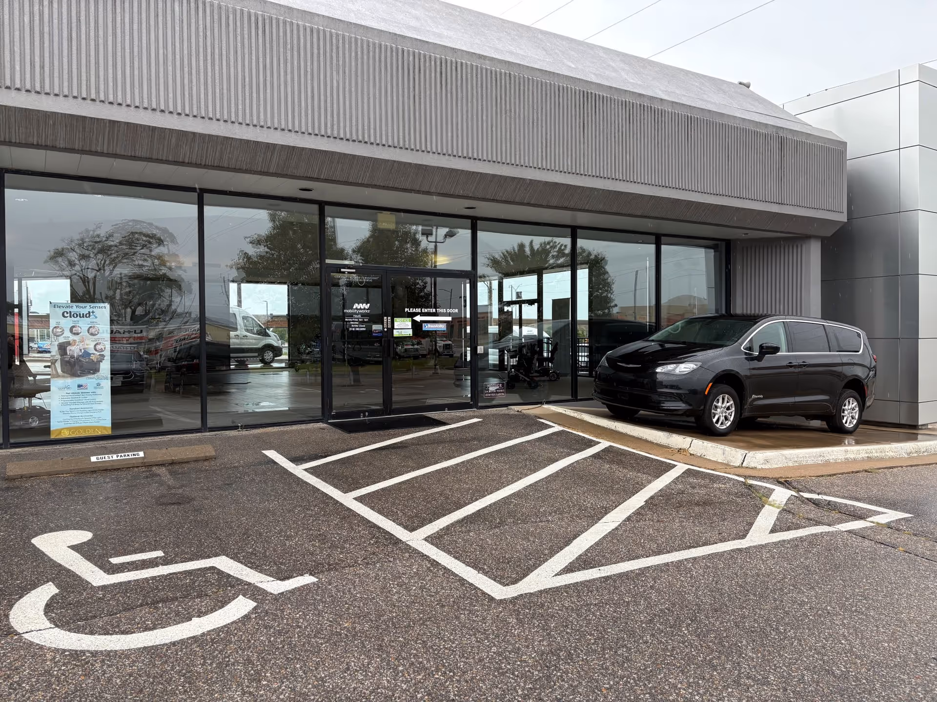 MobilityWorks storefront with glass doors, handicap parking, and a dark van outside.