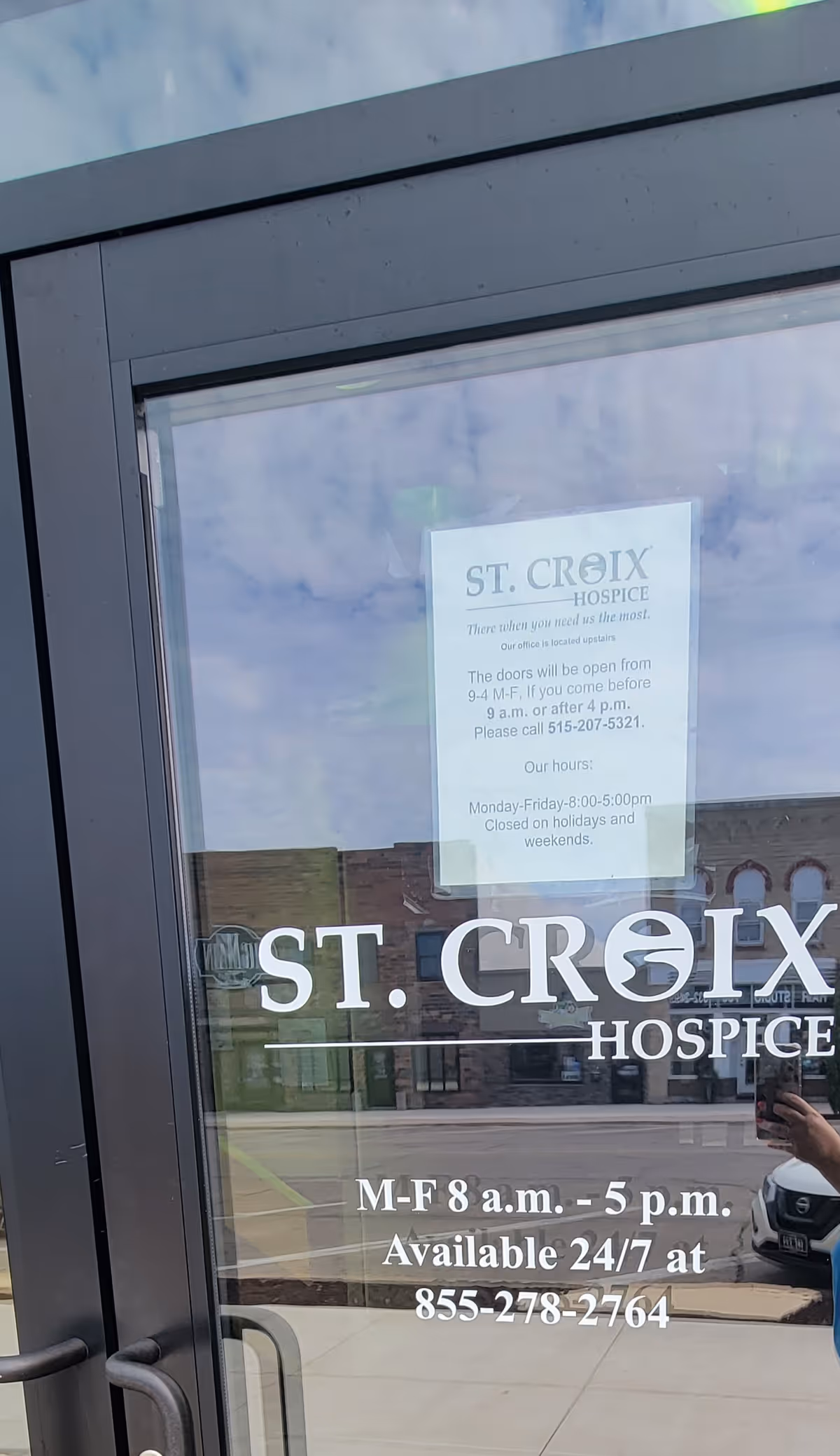 Front glass door for St. Croix Hospice showing signage and hours.